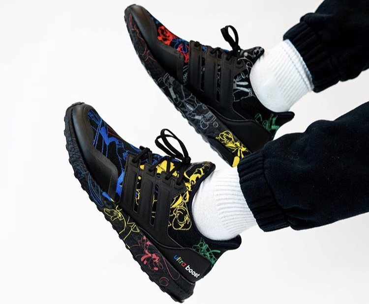 Black Disney x adidas Ultra Boost Goofy sneakers worn on foot