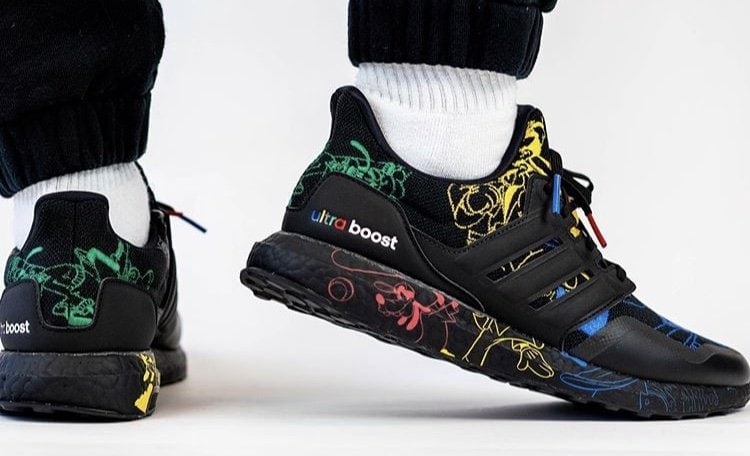 Side and heel view of black Disney x adidas Ultra Boost Goofy sneakers