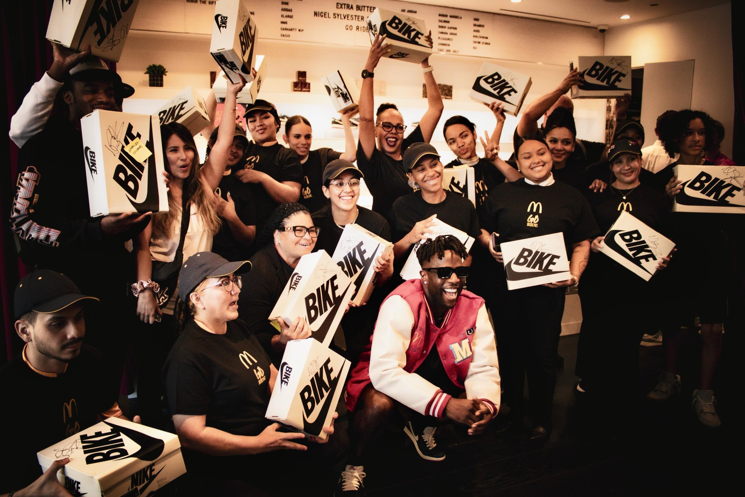 Nigel Sylvester smiling with McDonald’s employees after gifting them “Better With Time” Air Jordan 1 Low sneakers at Extra Butter NYC.