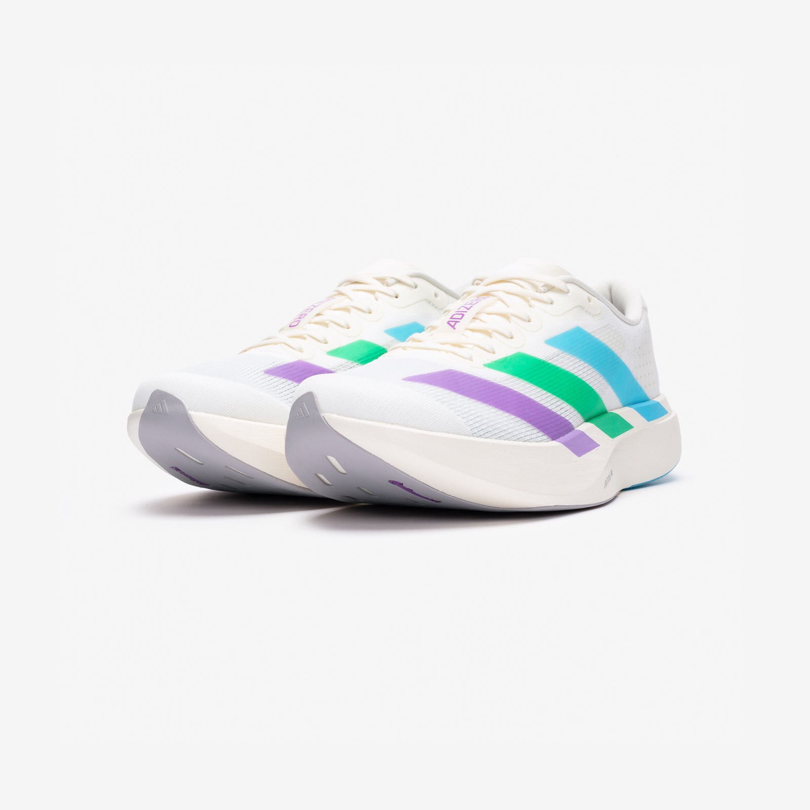 Front three-quarter view of the Speed Is Not a Sport Adizero Evo SL pair with grey toe bumpers and purple adidas logos