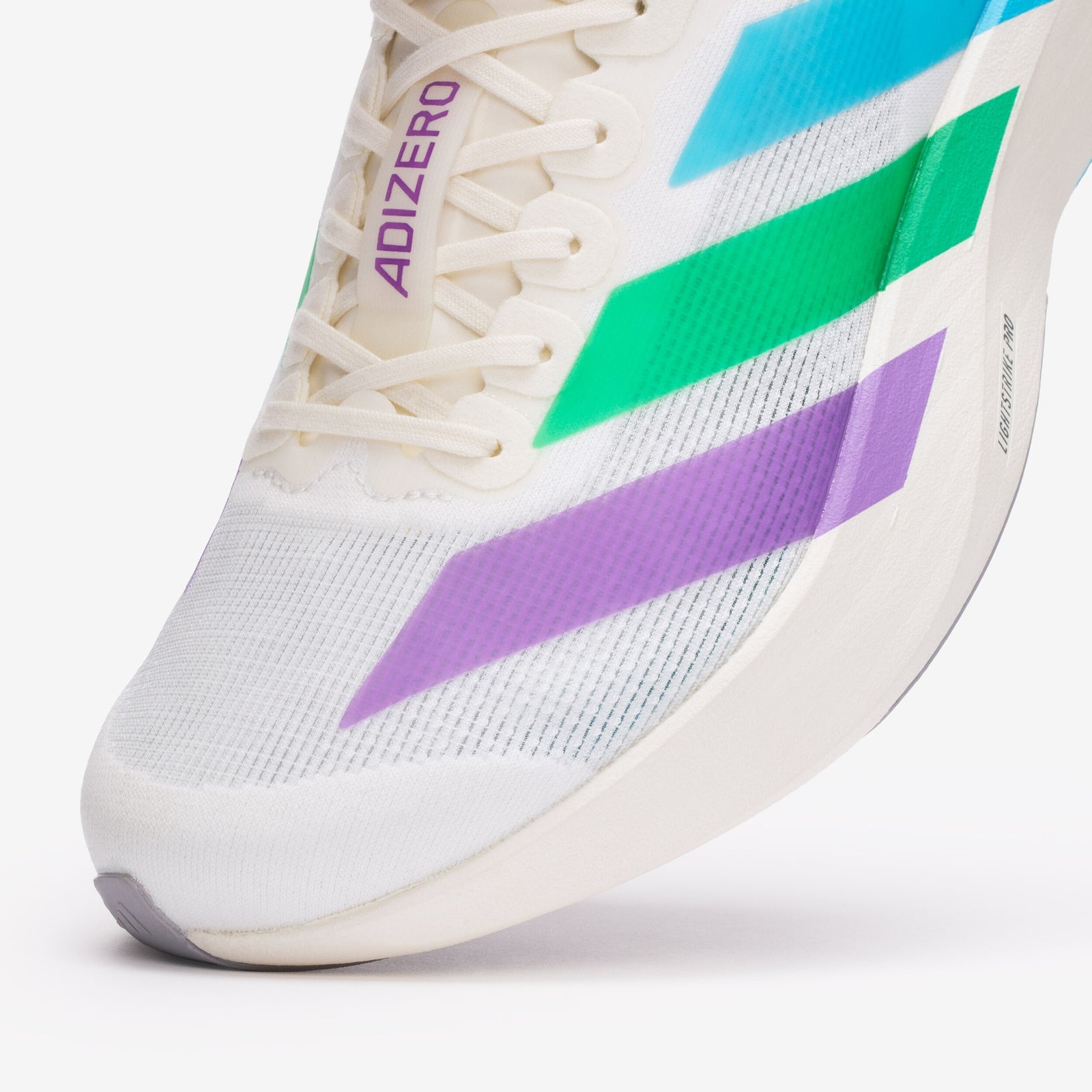 Close-up of the semi-transparent Three Stripes shifting from purple to green to blue on the cream mesh upper