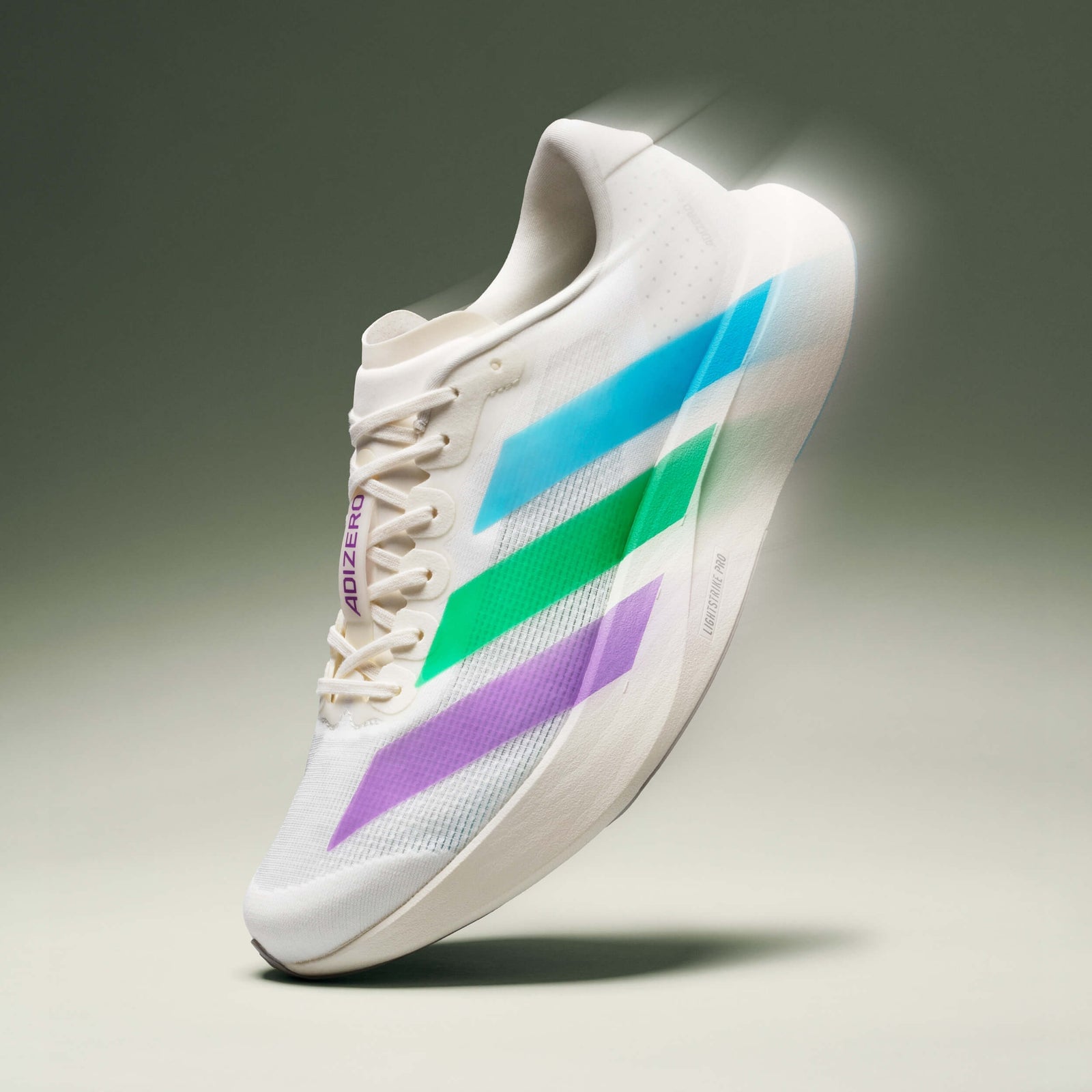 SNS Adizero Evo SL floating against a green backdrop, off-white mesh upper with a shifting blue-to-purple stripe gradient