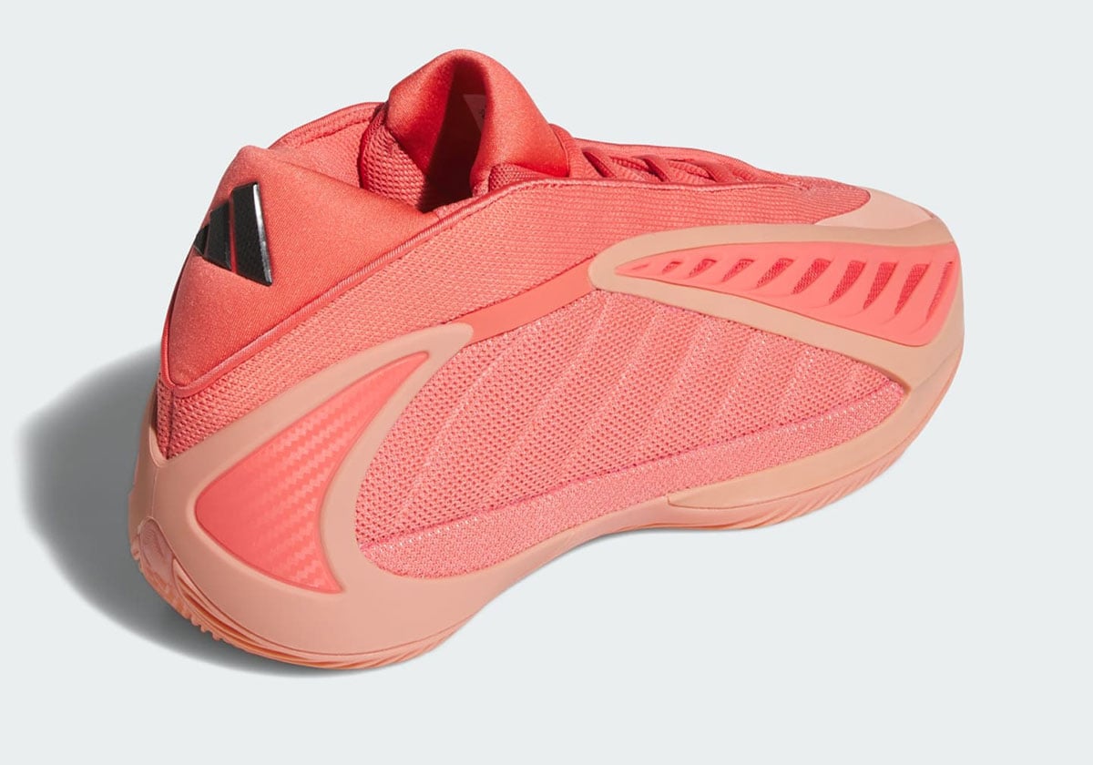 Rear three-quarter view showing the heel and black adidas badge on the coral Anthony Edwards 2 Georgia Red Clay