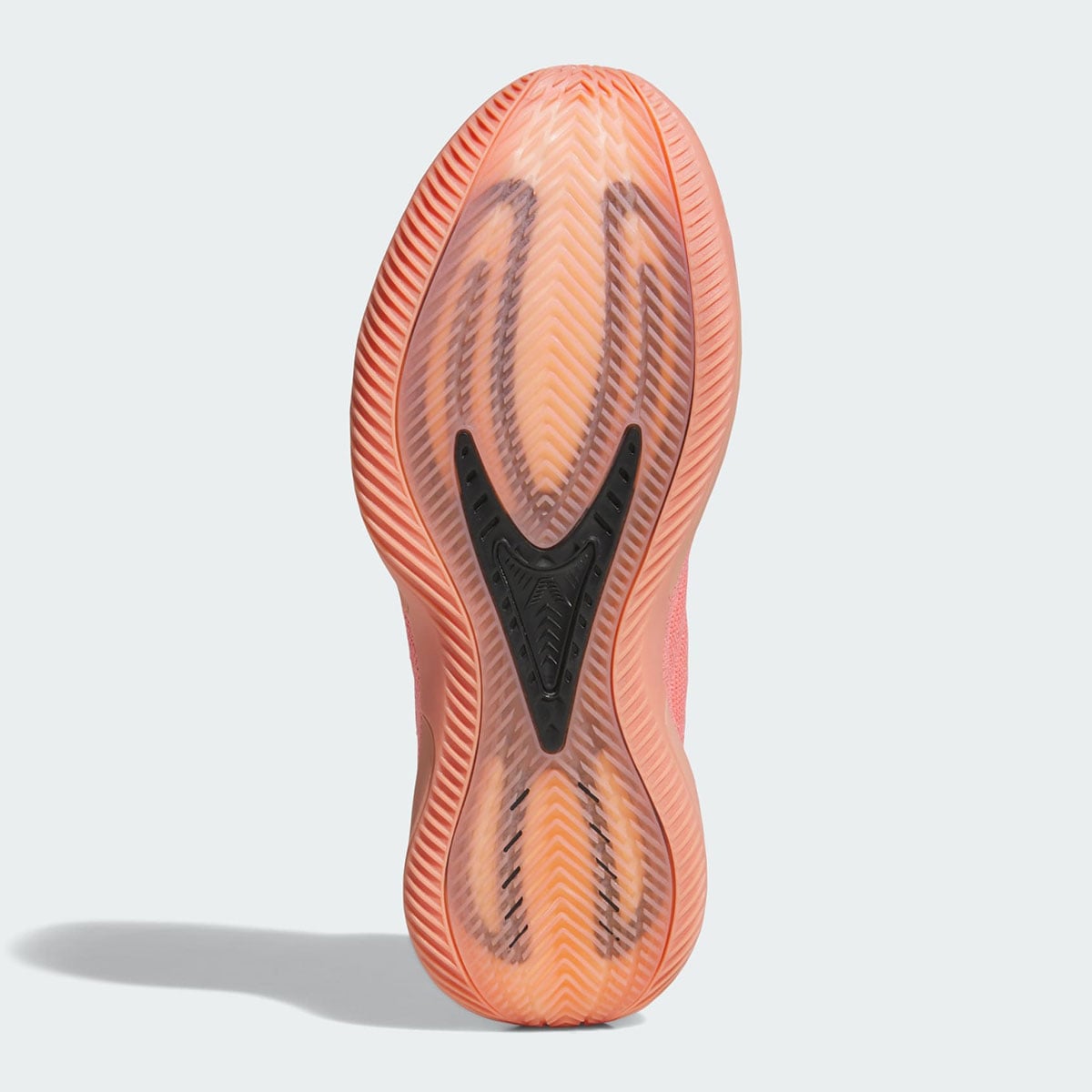 Translucent gum outsole of the Anthony Edwards 2 with herringbone tread and a black AE fang logo at the pivot
