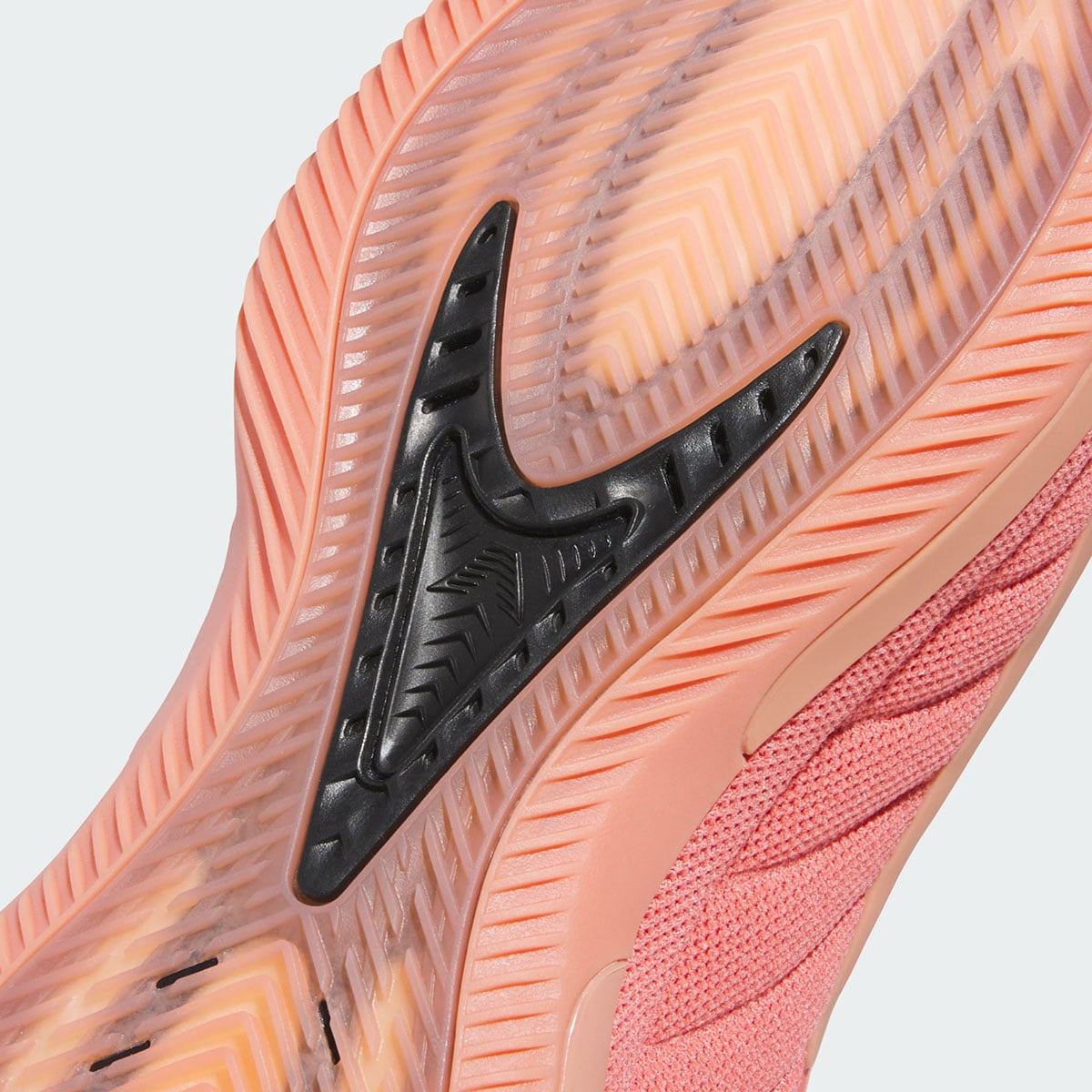 Macro of the black AE fang logo set into the translucent herringbone outsole of the Anthony Edwards 2