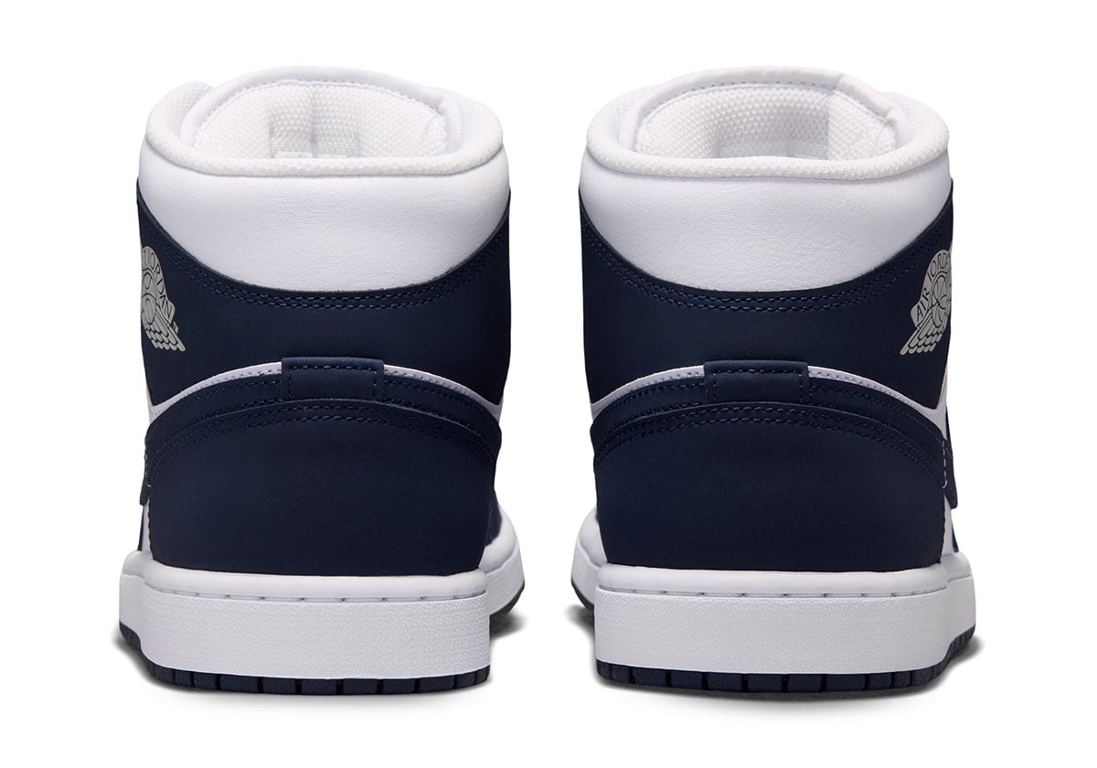 Heel view of the Air Jordan 1 Mid Obsidian with navy counters and grey embroidered Air Jordan Wings logos