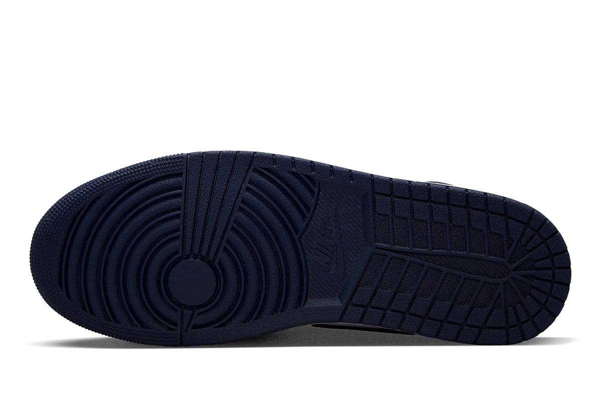 Solid navy rubber outsole of the Air Jordan 1 Mid Obsidian with Nike branding on the heel