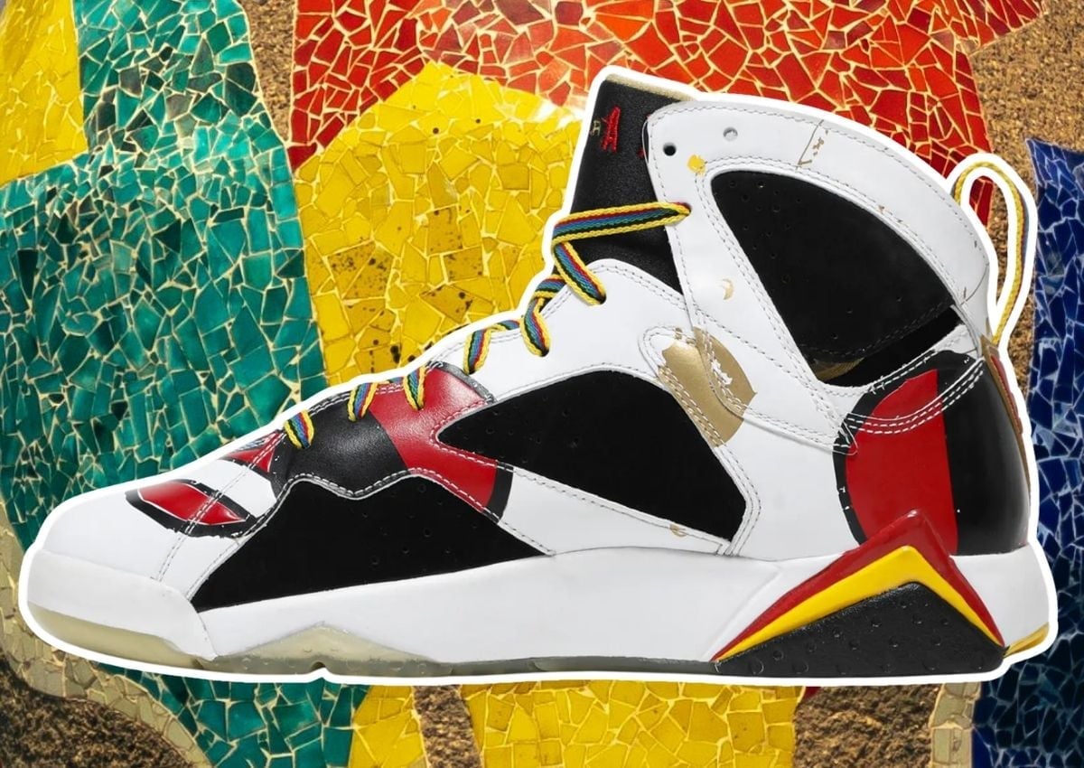 Side profile of the Air Jordan 7 Olympic Miro highlighting the red and yellow abstract artwork across the black nubuck panel