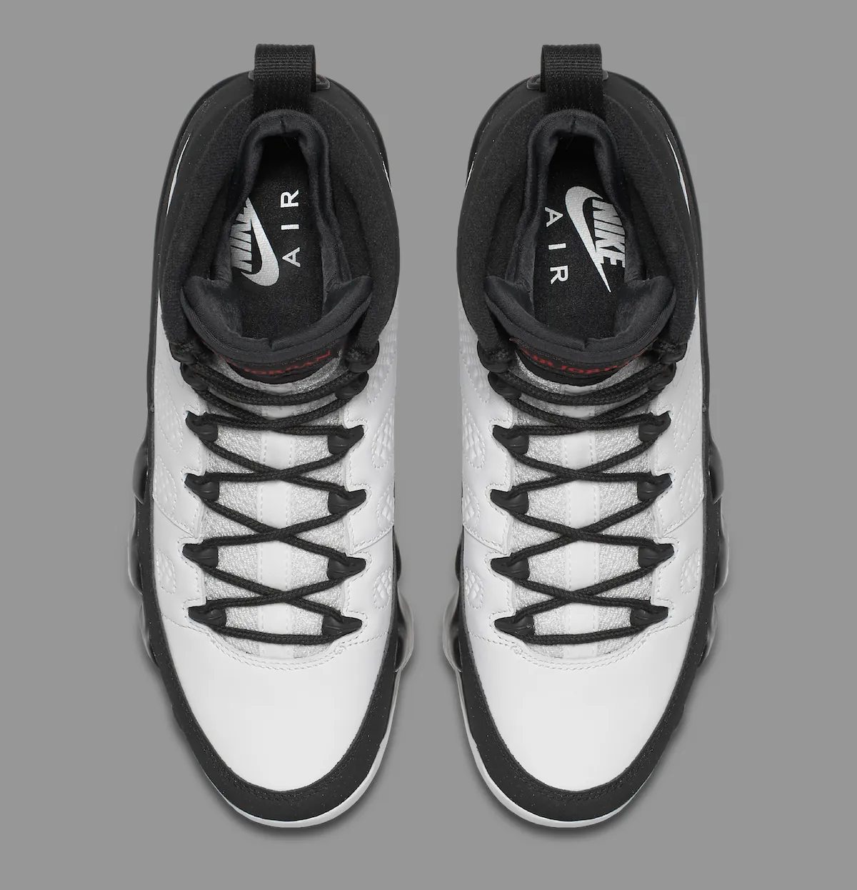 Top-down look at the white leather tongues with silver NIKE AIR branding on the Air Jordan 9 Retro