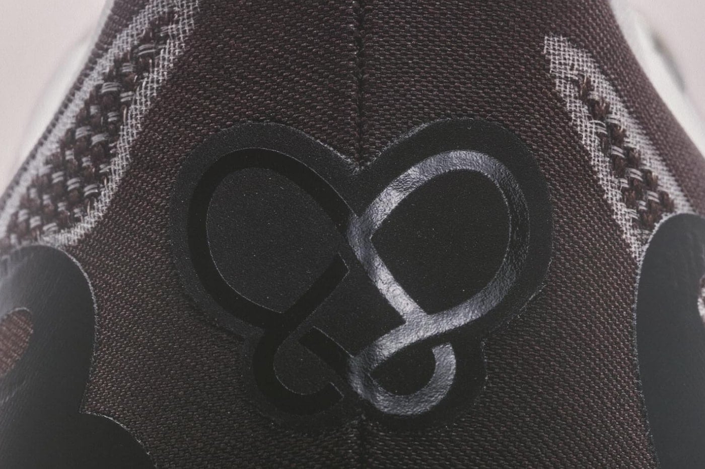 Close-up of the blacktoes looped butterfly logo debossed in black on the brown toe box of the Superblast 3 BT