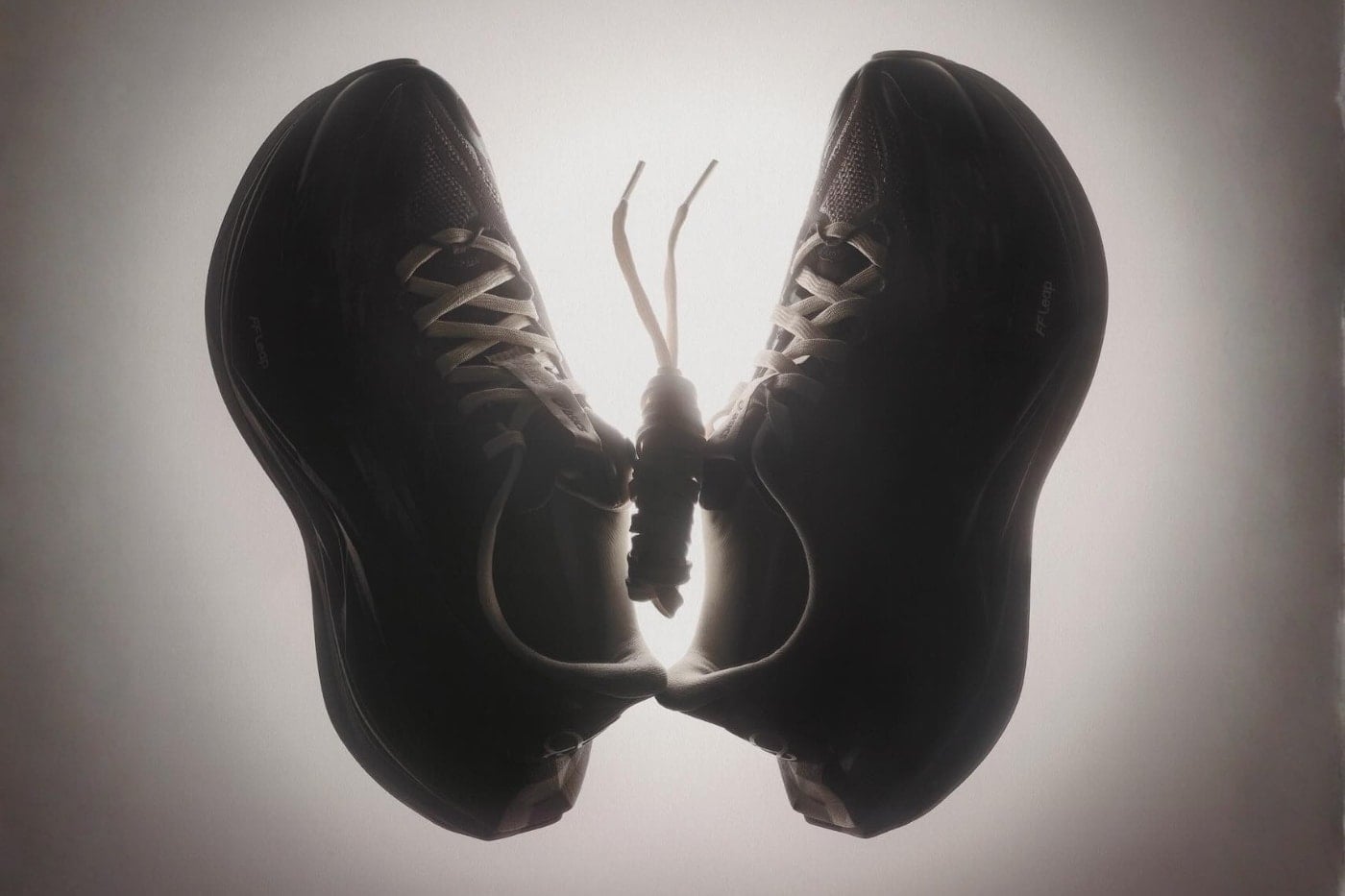 Moody silhouette of the blacktoes Superblast 3 pair posed as butterfly wings, showing the FF Leap foam midsole profile