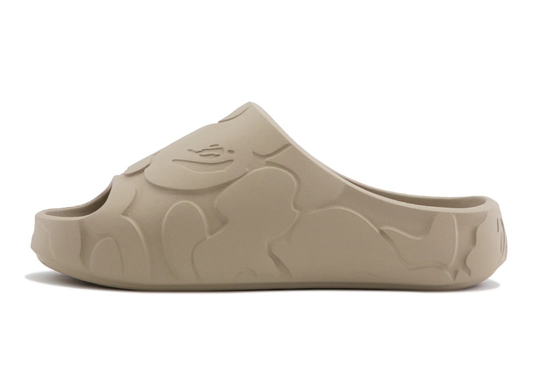 Lateral profile of the beige BAPE Slide showing the sculpted Solid Camo relief along the midsole wall
