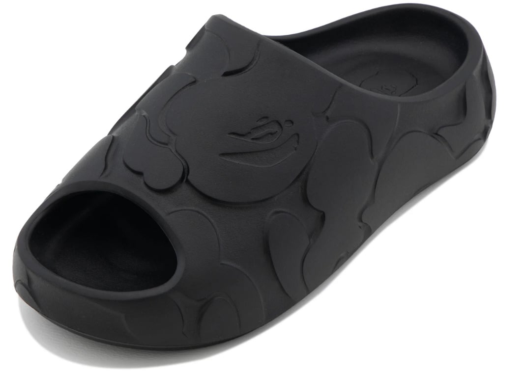 Top-down view of the black slide showing the embossed ape head motif on the forefoot strap