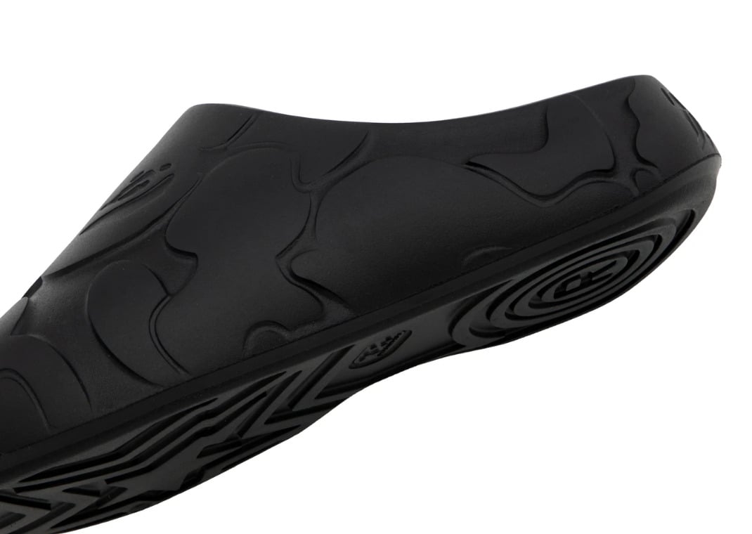 Outsole detail on the black slide with the radial heel swirl and star-shaped forefoot traction