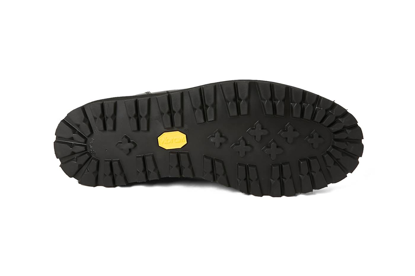 Outsole detail of the lugged Vibram tank sole on the N.Hoolywood Danner Postman Shoes, yellow Vibram badge centered