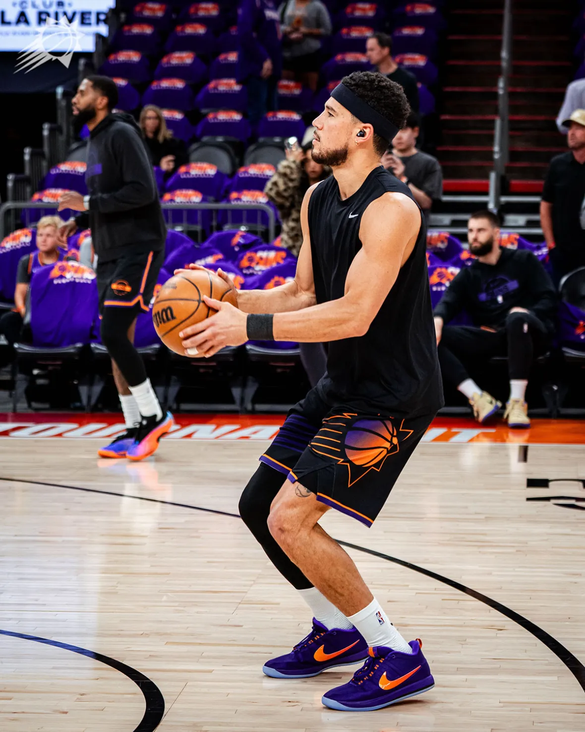 Devin Booker in a shooting stance during Suns warmups wearing the purple Nike Book 2 Sunburst PE