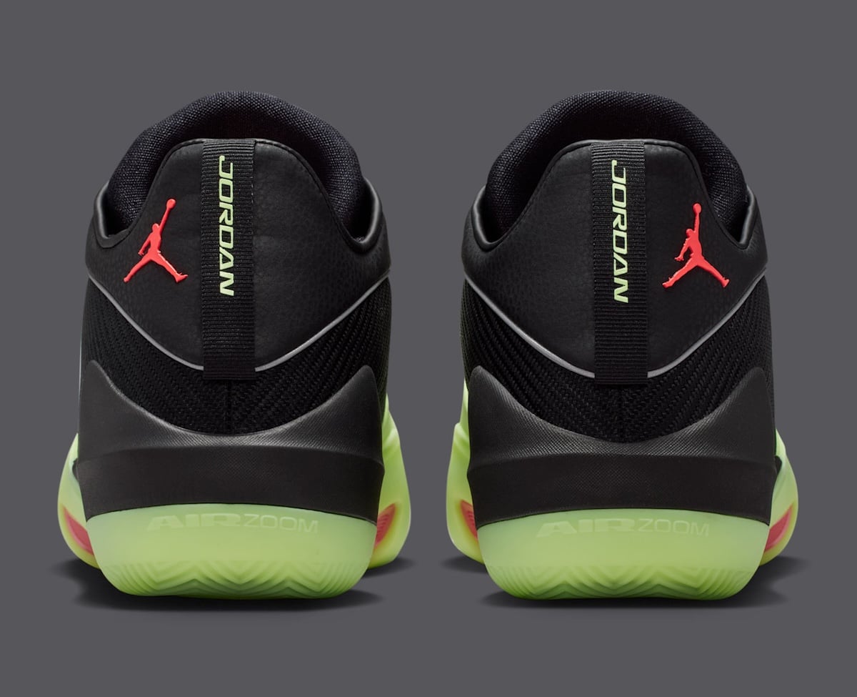 Heel view of the Black Barely Volt Triangle, with the AIR ZOOM unit molded into the glow-green sole and JORDAN pull-tabs