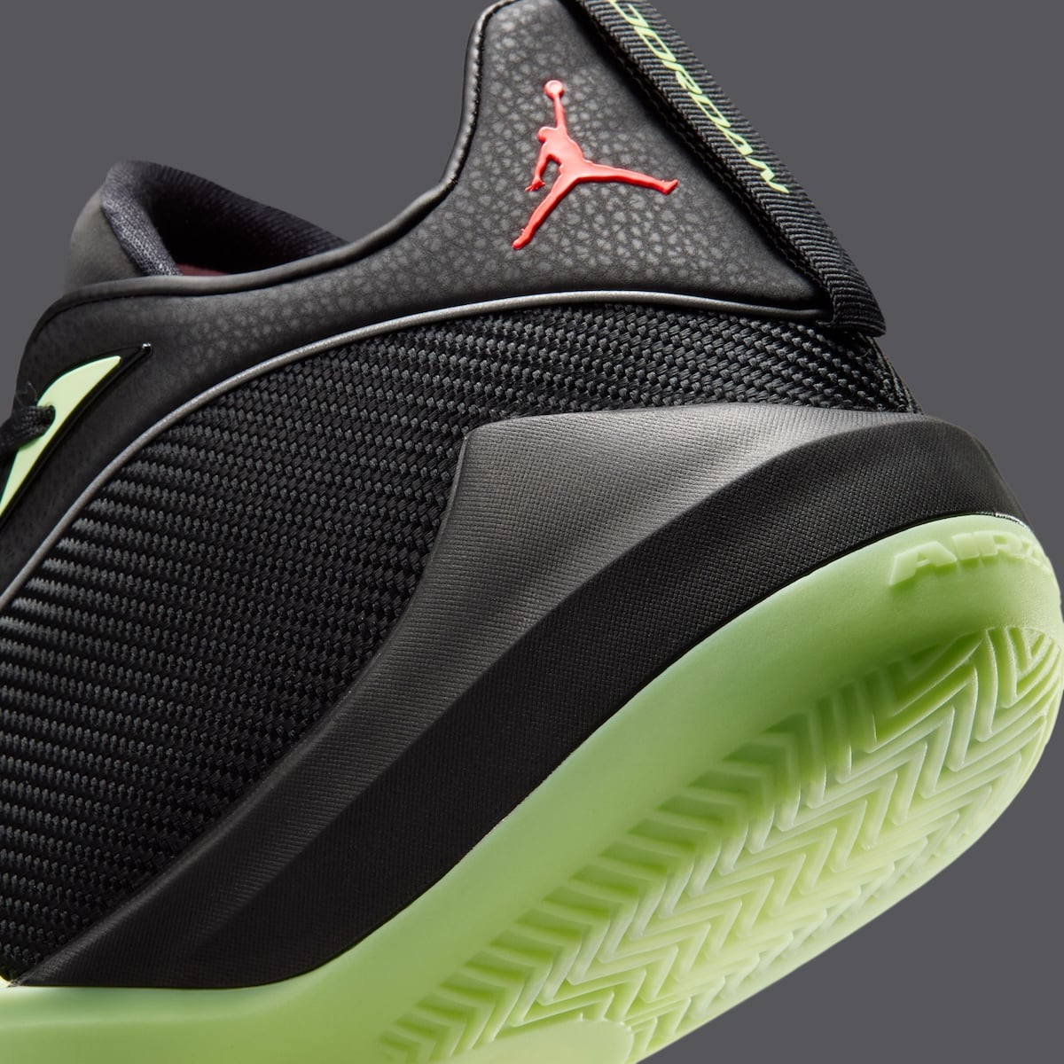 Macro detail of the woven black upper, ZoomX branding and herringbone Barely Volt outsole on the Jordan Triangle
