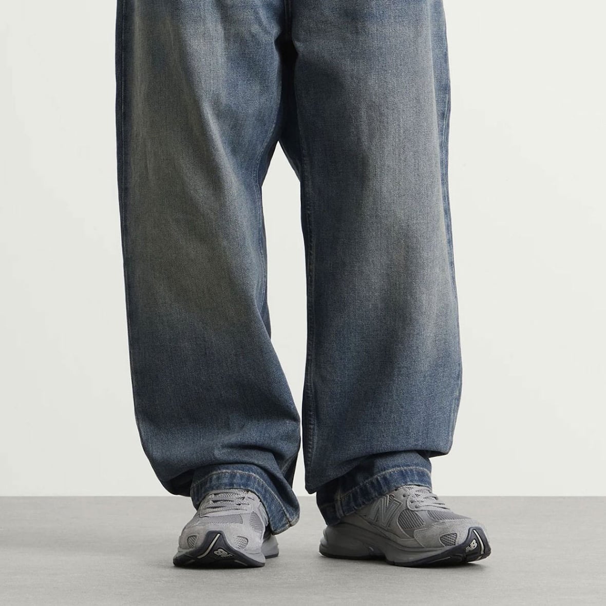 On-foot look at the tonal grey New Balance 2010 Harbor Grey worn with faded baggy denim jeans