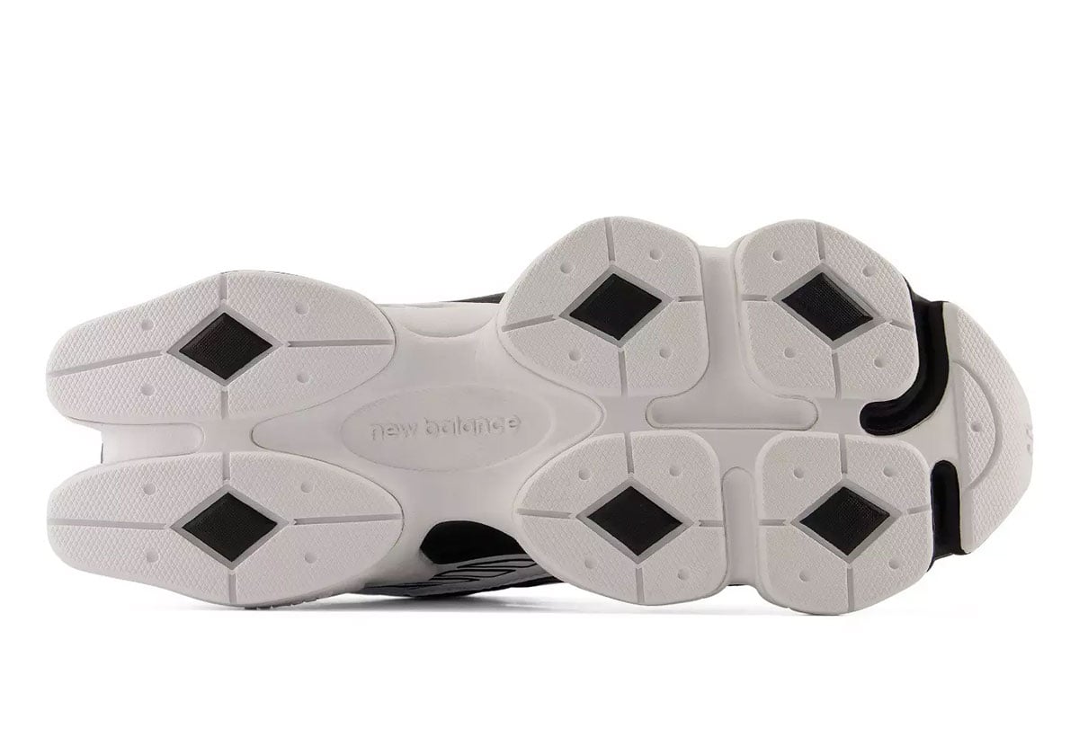 Outsole of the New Balance 9060R, a white tooling with black diamond rubber pods and embossed New Balance text