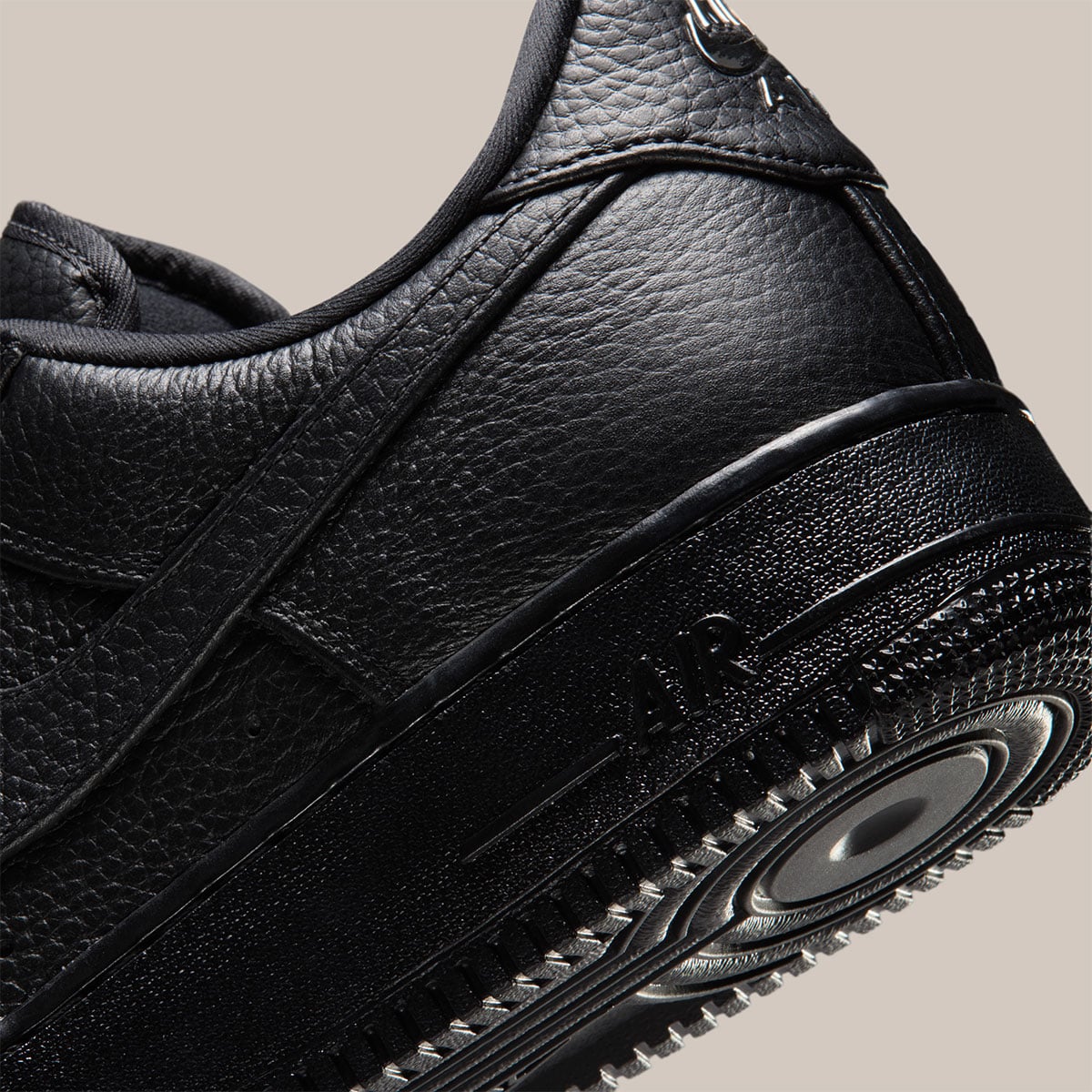 Close-up of the glossy black AIR midsole and encapsulated heel Air unit on the leather Air Force 1 Low