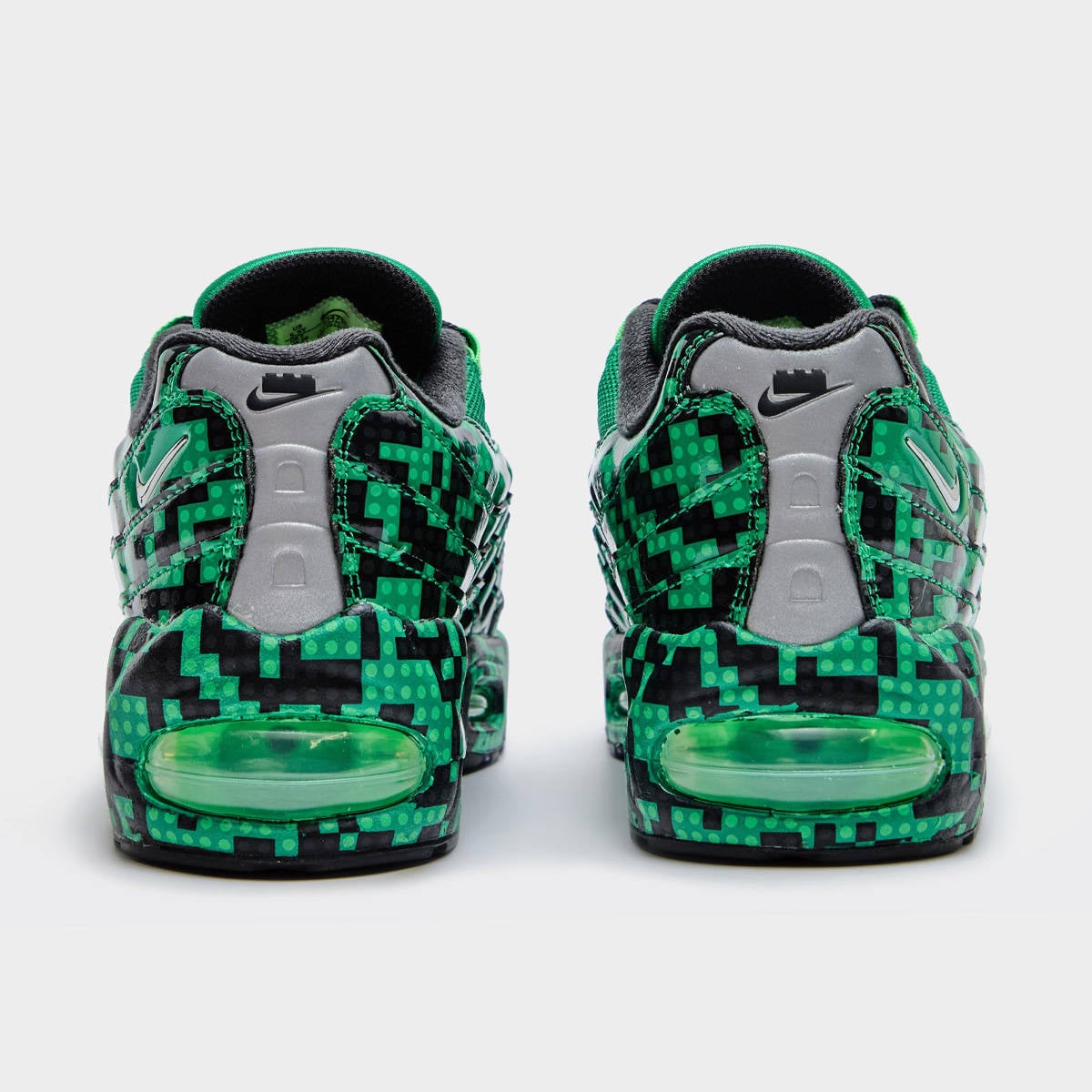 Heel view of the LEGO x Nike Air Max 95 Lucky Green, with a metallic silver counter, black Swoosh, and a green visible Air unit