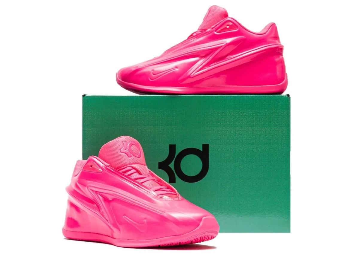 Two Hyper Pink KD 19 sneakers staged with the Stadium Green KD shoe box and its black KD logo