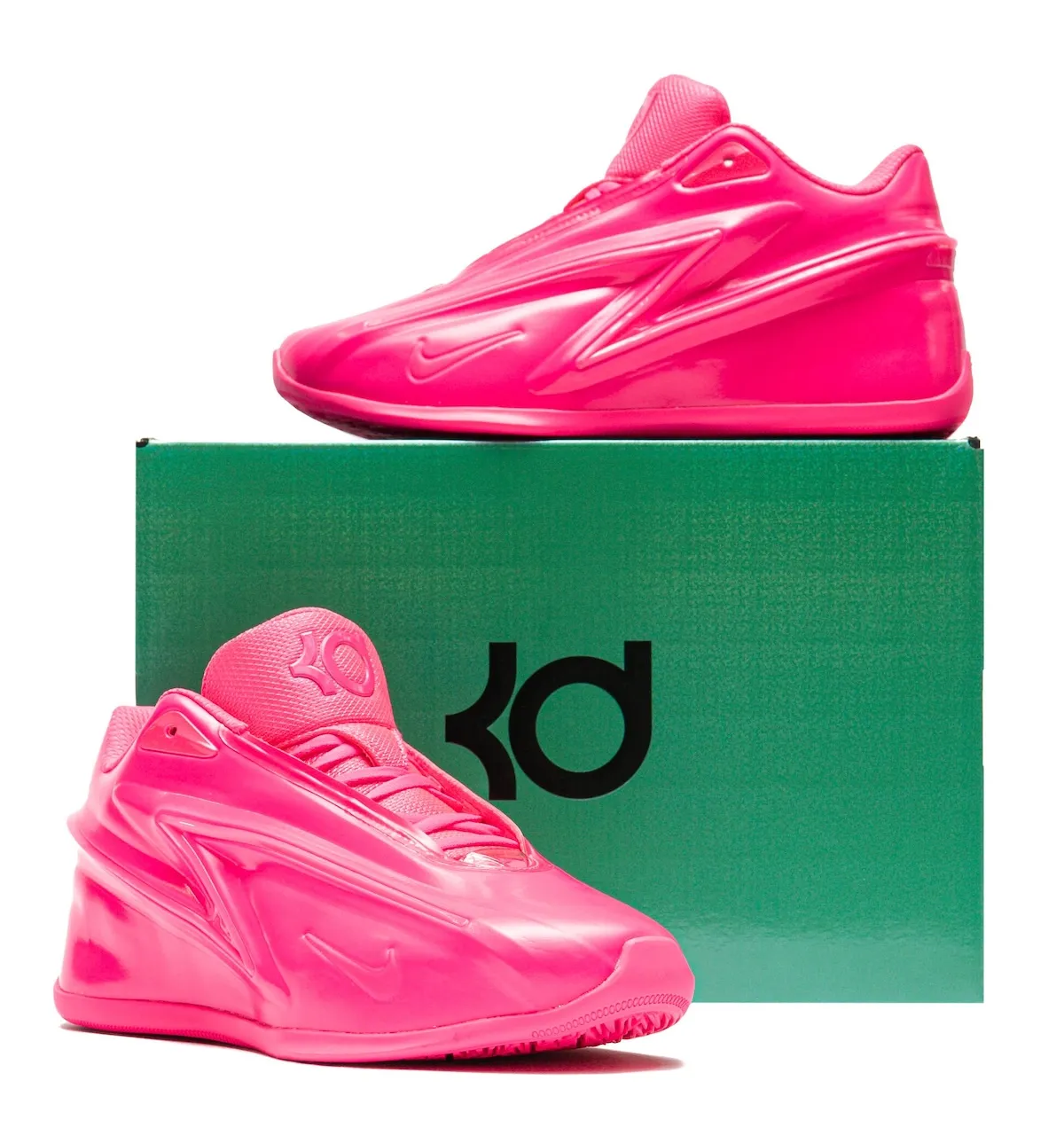Vertical staging of the Hyper Pink KD 19 with the Stadium Green KD box and black logo behind the pair