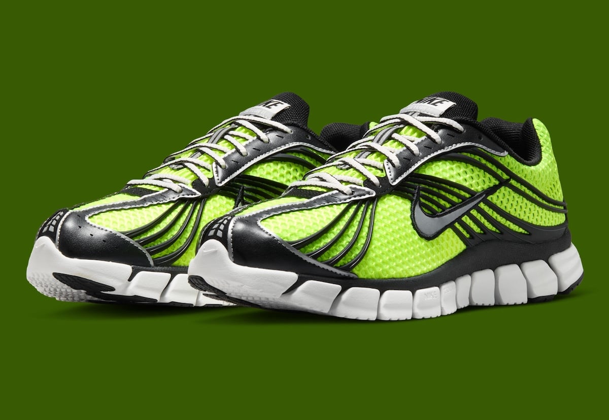 Front three-quarter view of the Nike Zoom Skylon 11 Volt pair on an olive backdrop with black toe caps and white midsoles