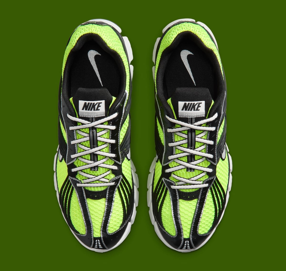 Top-down view of the volt running shoe pair showing the black tongue with NIKE Skylon 11 branding and a silver insole Swoosh