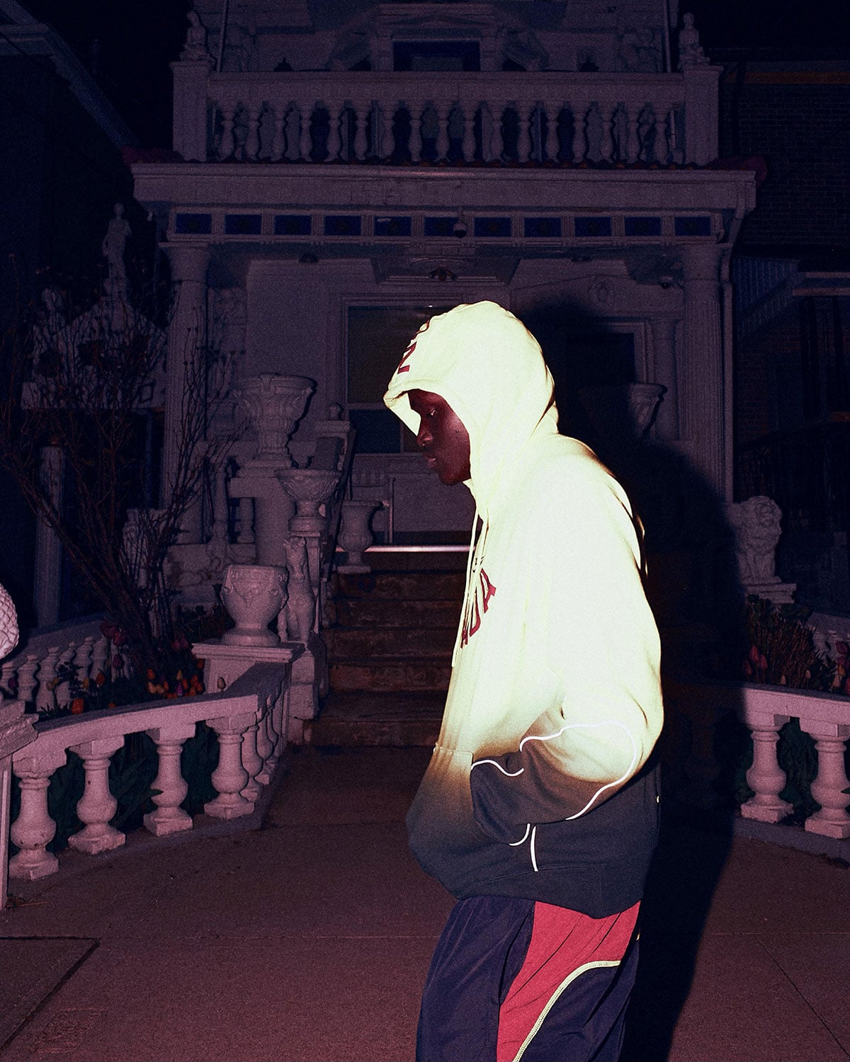 NOCTA Team Canada glow-trim hoodie and track pants worn on a porch at night