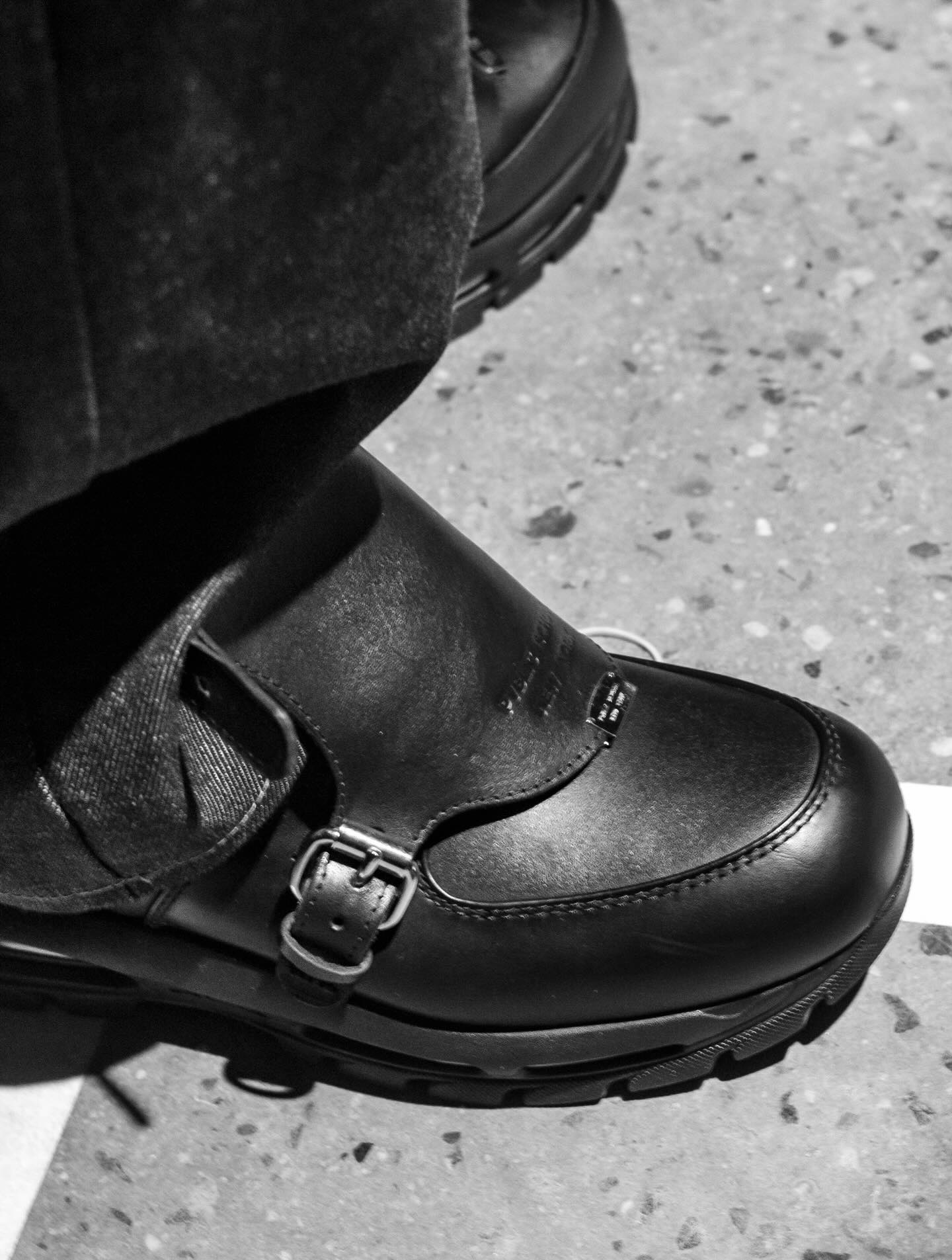 On-foot styling of the Public School New York Air Max Goadome over a terrazzo floor, monk-strap buckle in focus