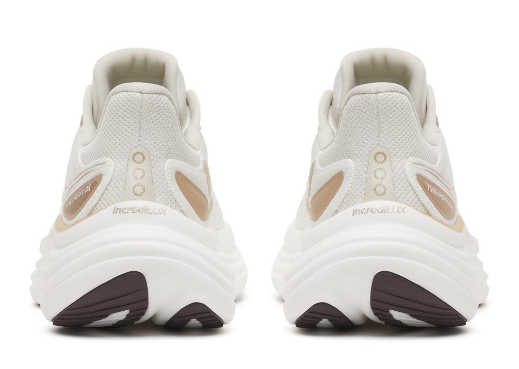 Heel view of the ivory pair showing the gold Saucony logos and the wavy stacked IncrediLUX midsole