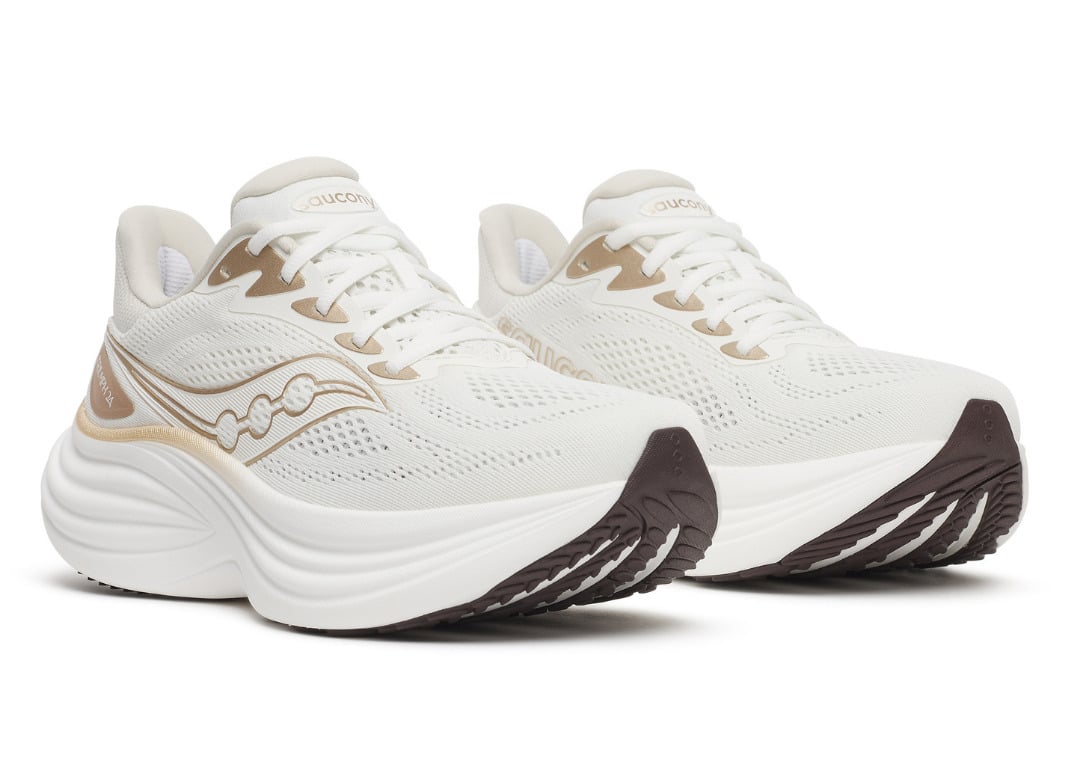 Front three-quarter look at the Ivory/Eggshell pair with gold accents and a brown carbon rubber outsole