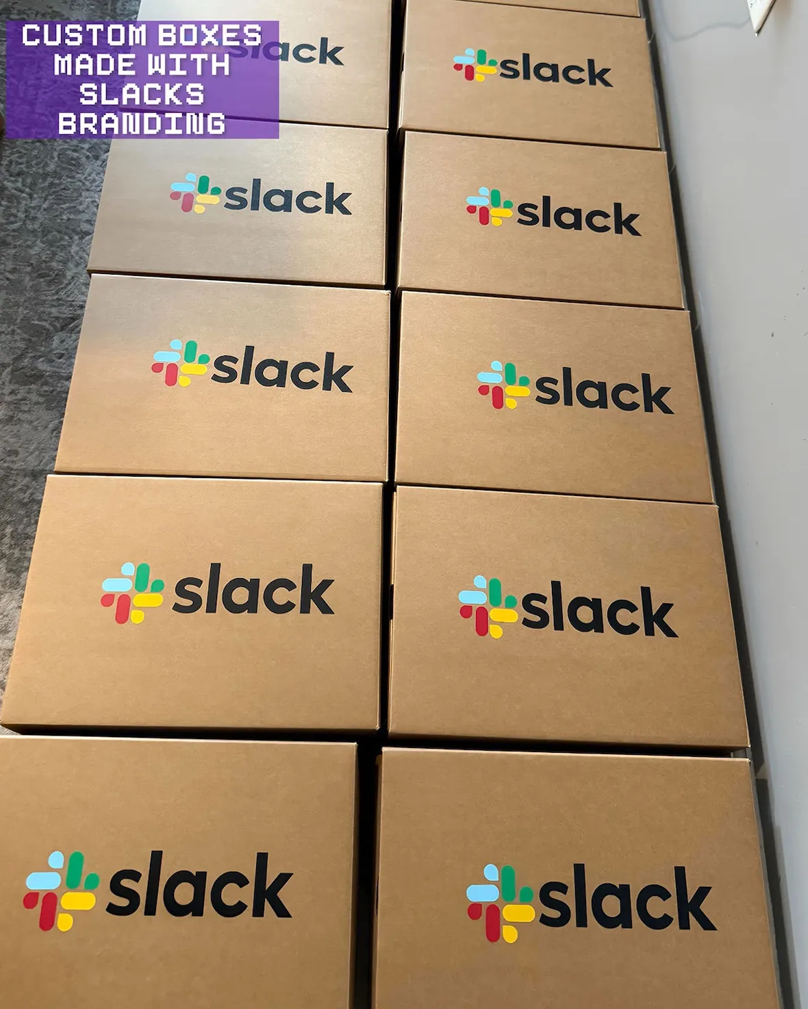Stack of custom shoe boxes printed with the Slack logo that the Nike Dunk and Air Max 1 customs ship inside
