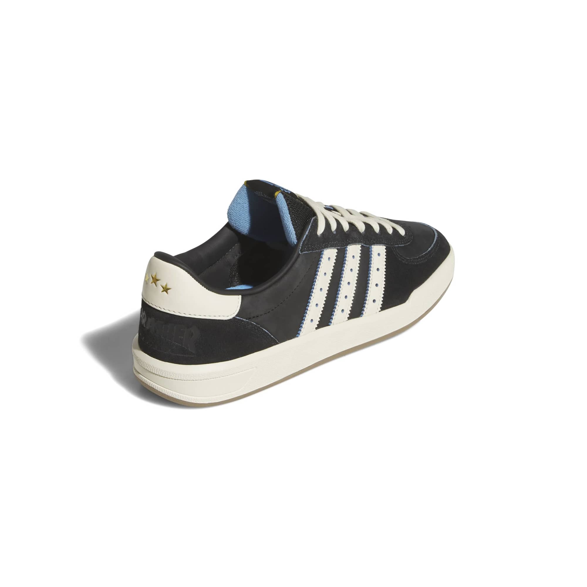 Back three-quarter view with three gold stars on the cream heel tab above a debossed Thrasher Revista logo