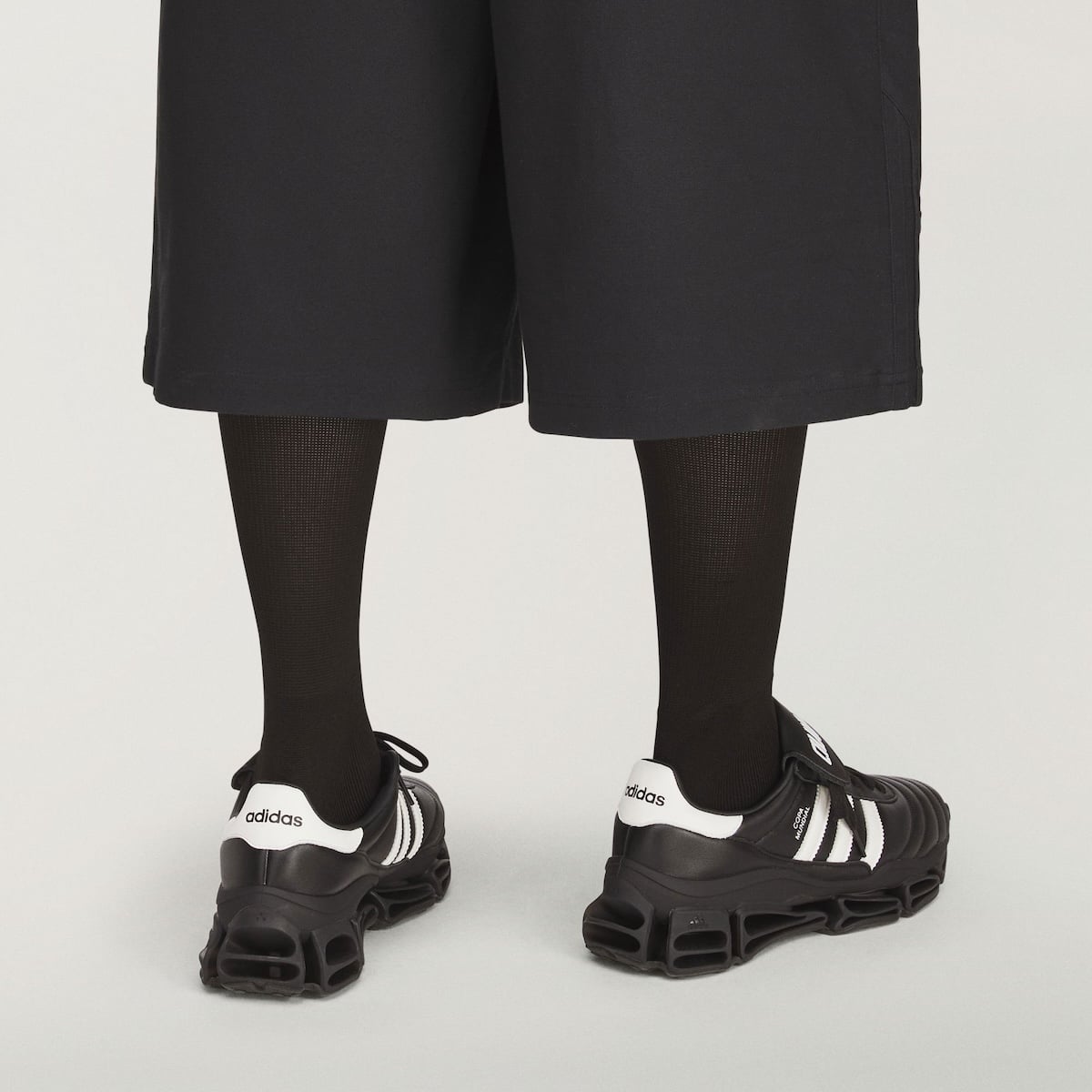 On-foot look at the black leather adidas Copa Mundial Megaride worn with black socks and wide black shorts