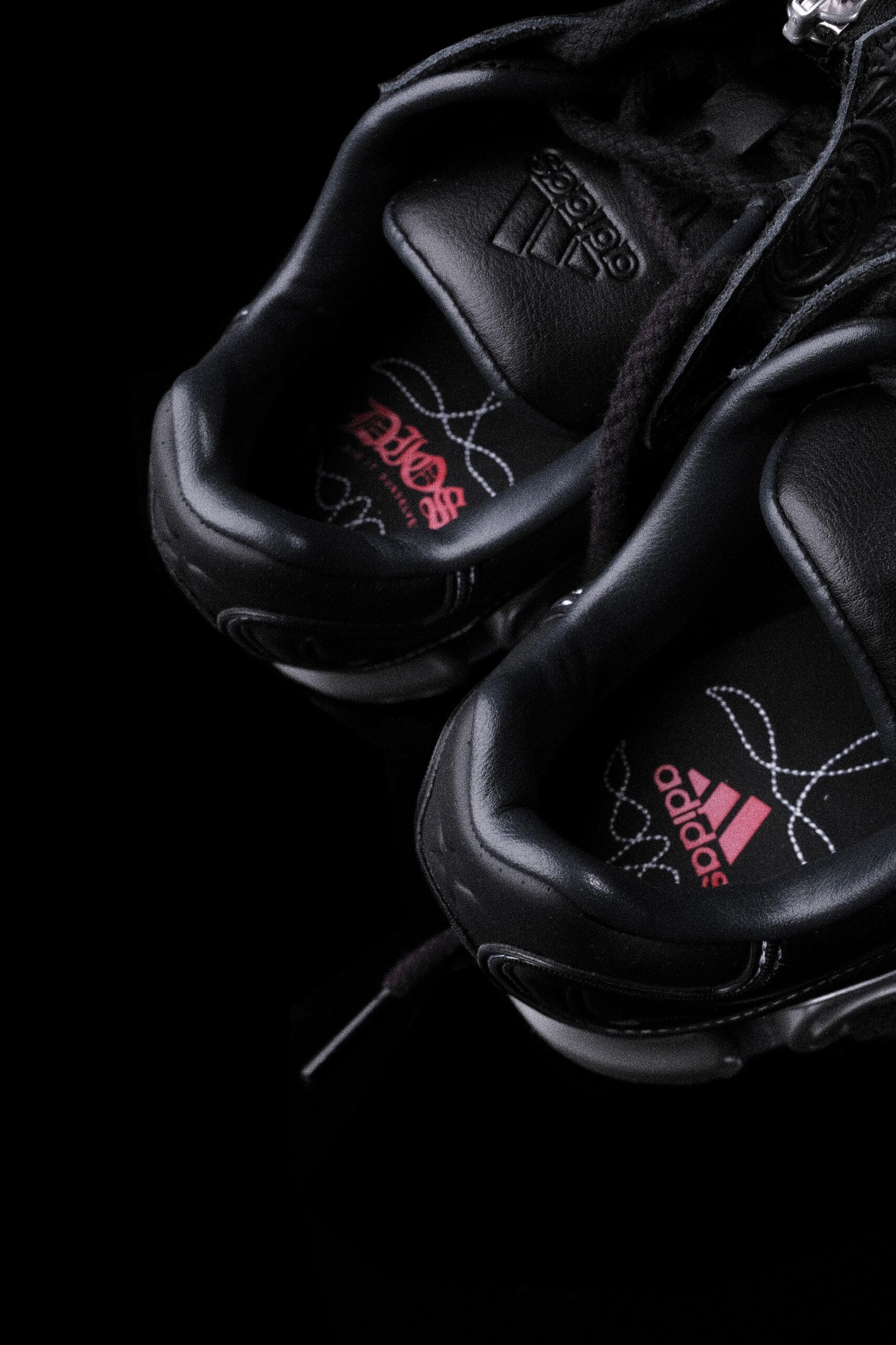top-down view of tongues, embossed adidas logo and pink DIOS wordmark on insoles, DIOS Megaride 01