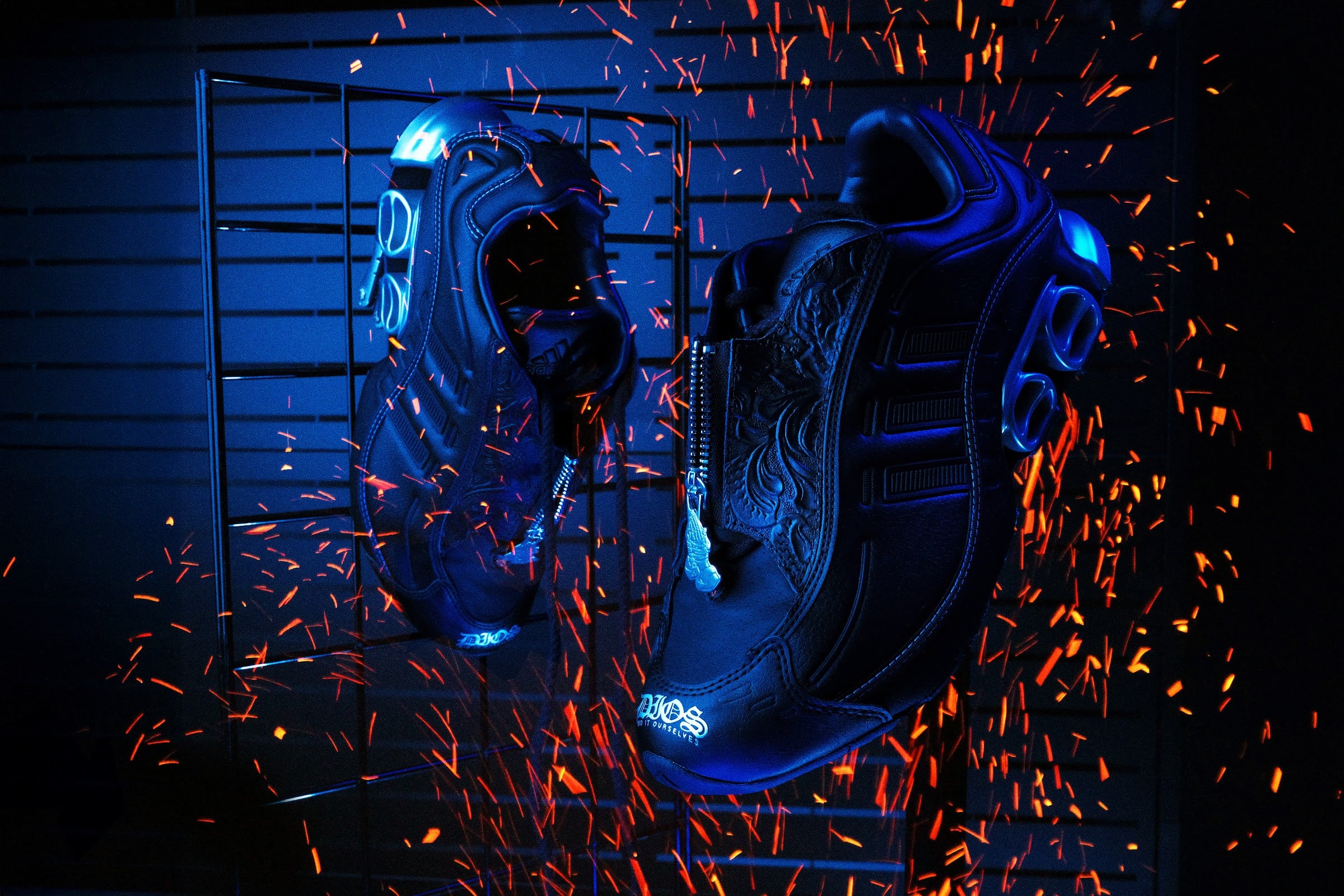 pair hanging, medial view showing zip closures, black leather under blue light, DIOS Megaride 01