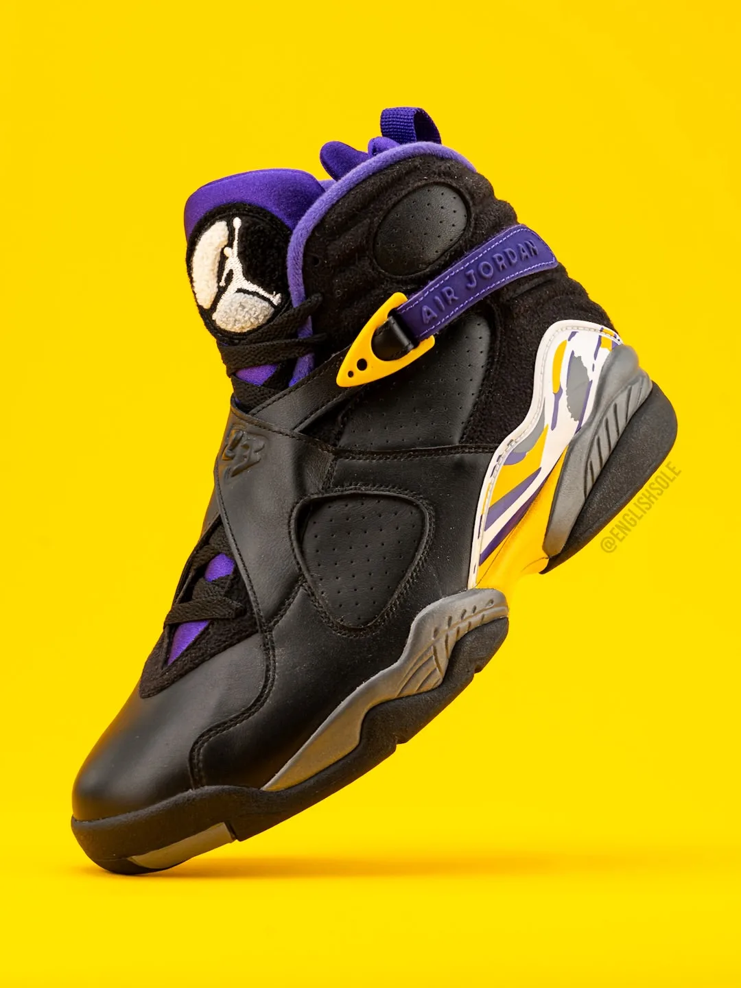 medial angled view, black upper with purple collar and yellow strap buckle, Bryant PE Pack