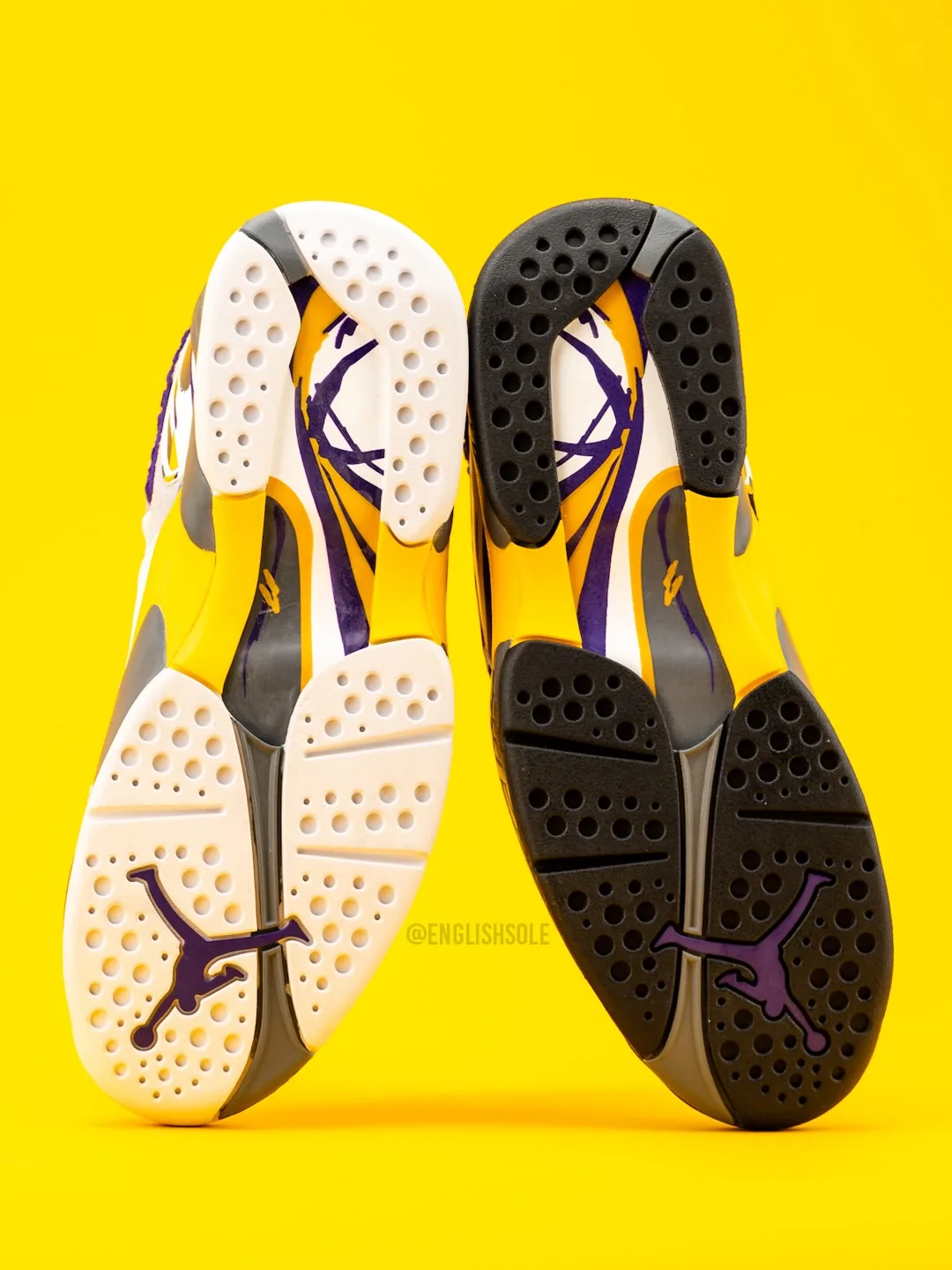 outsole view of pair, white and black soles with purple jumpman logo, Bryant PE Pack