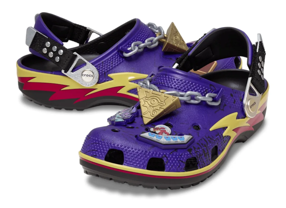 angled pair, purple clogs with chain, gold pyramid charms and lightning graphic, x Crocs Collection