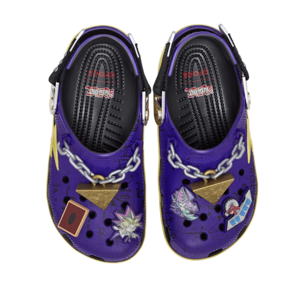 top-down pair, purple clog with gold pyramid charm and chain, red duel disk card, Yu-Gi-Oh x Crocs Collection