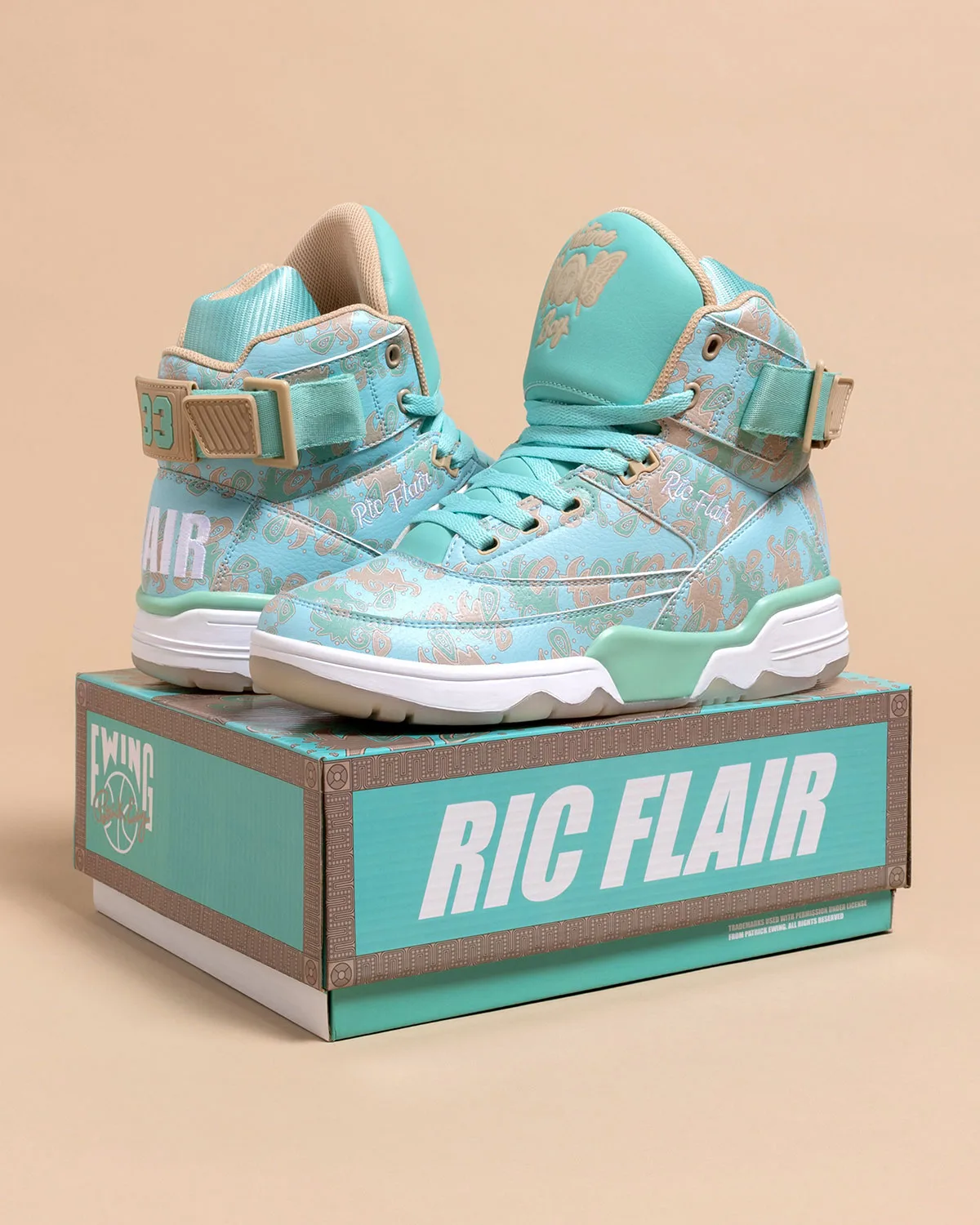 pair perched on teal Ric Flair box, turquoise paisley print with strap and 33 tag, x Ric Flair