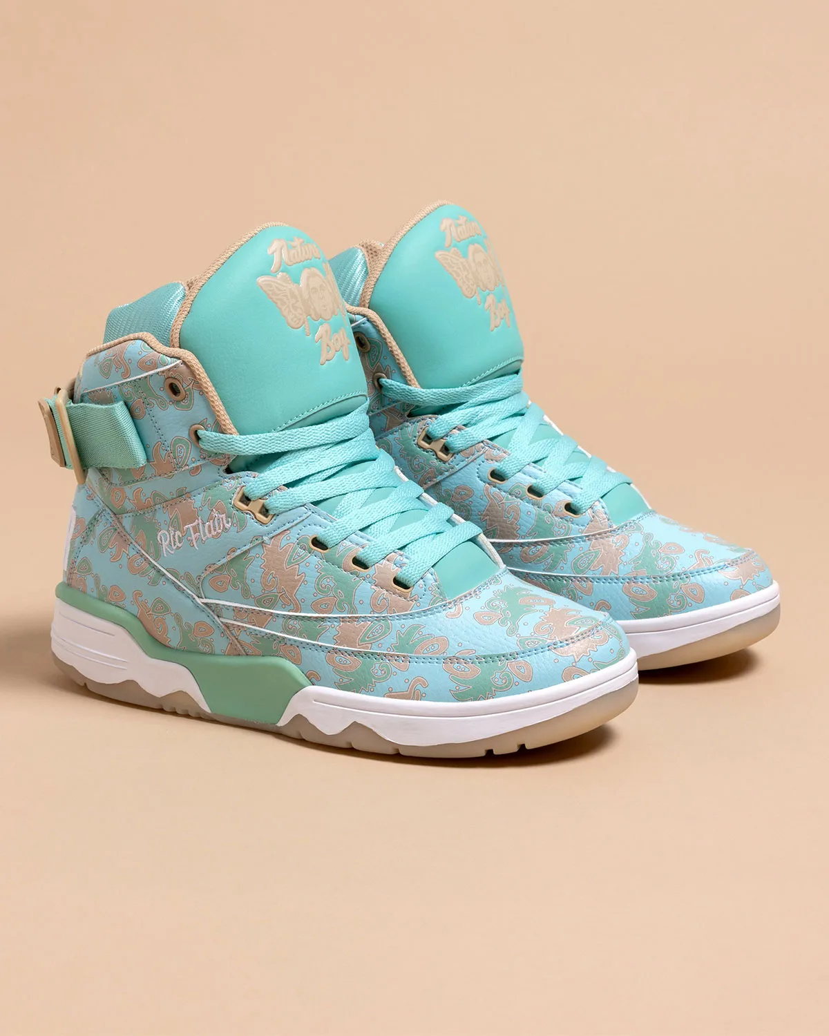 front angled pair, turquoise paisley upper with Nature Boy tongue graphic, x Ric Flair