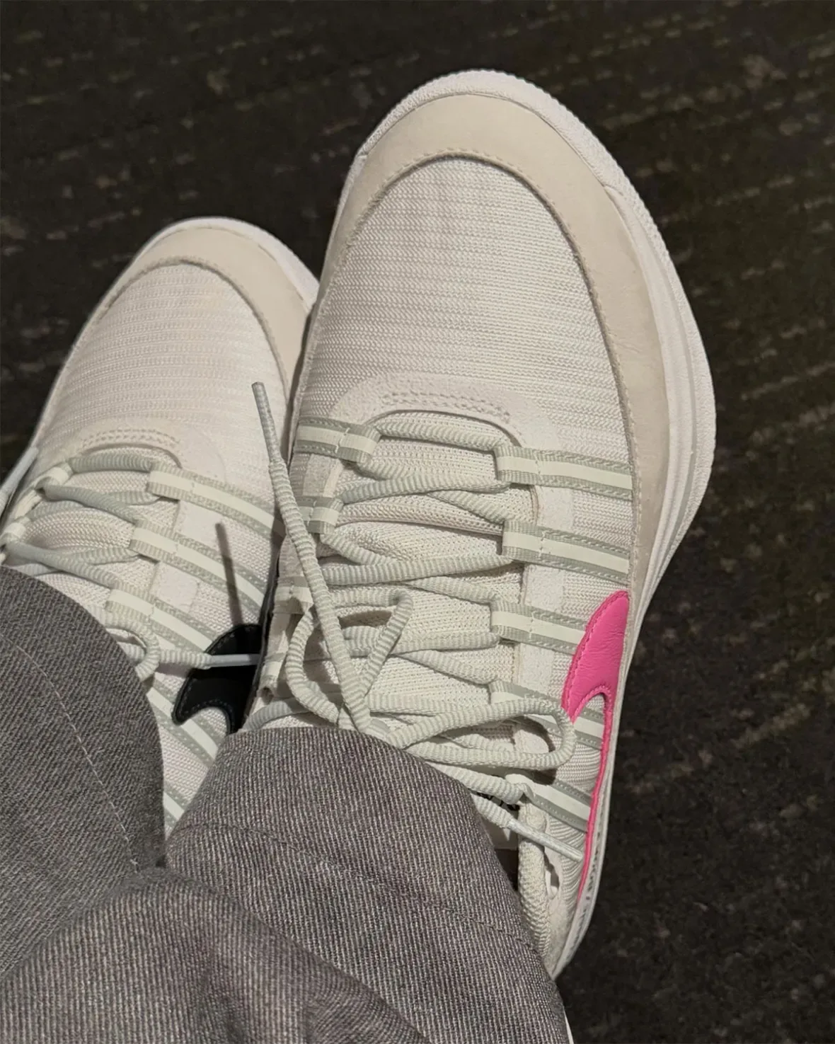 on-foot top-down view of laced white pair with pink swoosh on carpet, White and Pink