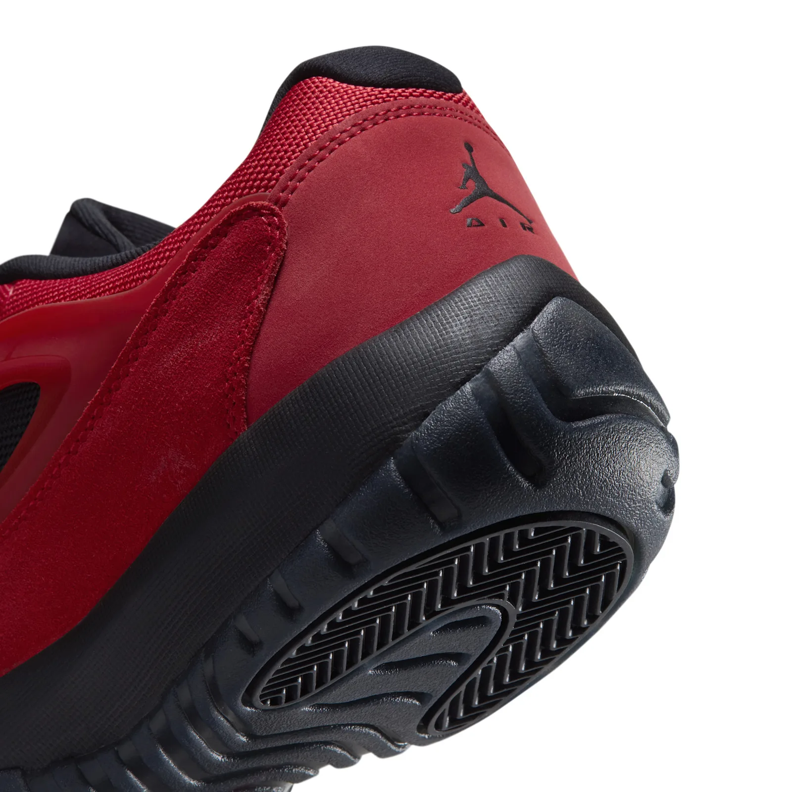 Close-up heel detail on yellow background, black Jumpman Air logo, Reverse Bred