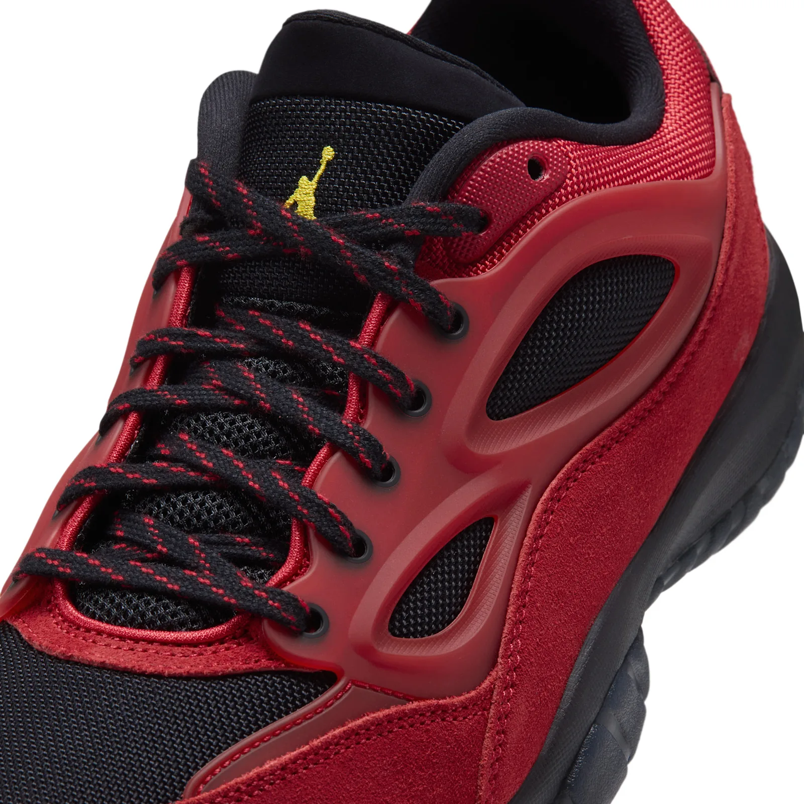 Close-up lace detail, black laces with red stitching, yellow Jumpman on tongue, Reverse Bred