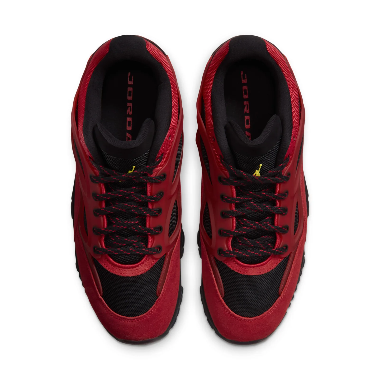 Pair heel view on yellow background, black Jumpman logo on red heel, Reverse Bred