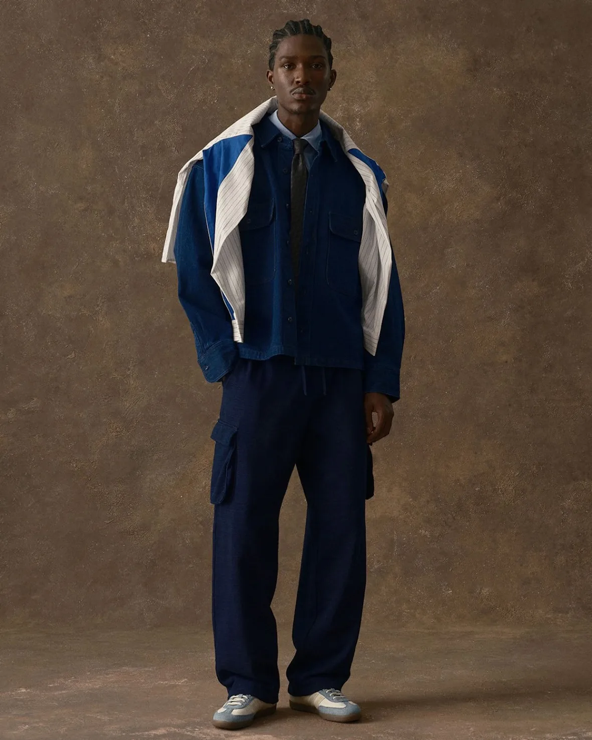 on-foot with denim jacket and navy trousers against brown backdrop, Denim